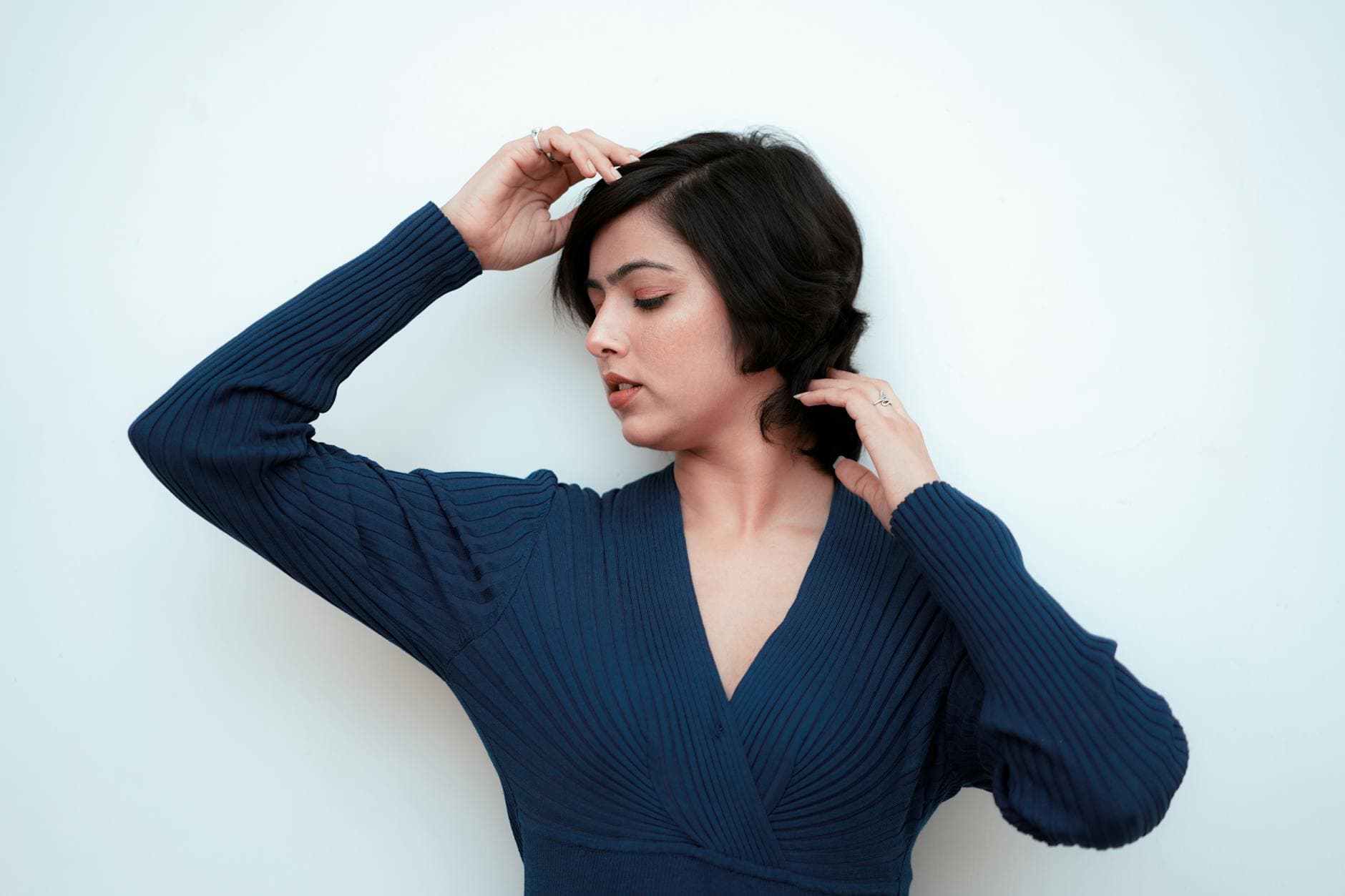 Serene portrait of a woman in a blue dress posing gracefully against white background. - how to apologize to boyfriend