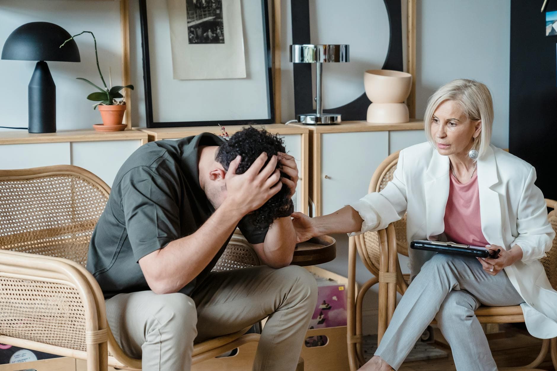 A supportive therapist provides comfort during a counseling session in a cozy office. - choose therapist seasonal depression