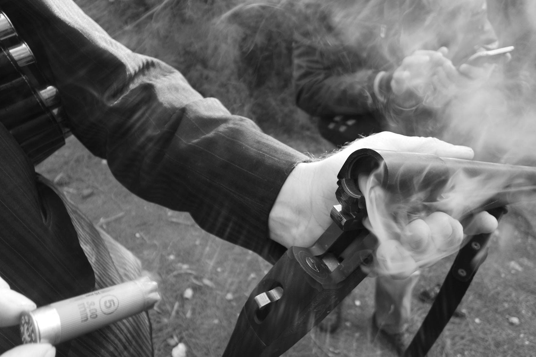 Detailed shot of a hand holding a smoking shotgun, highlighting the action and movement. - seasonal eating disorder triggers