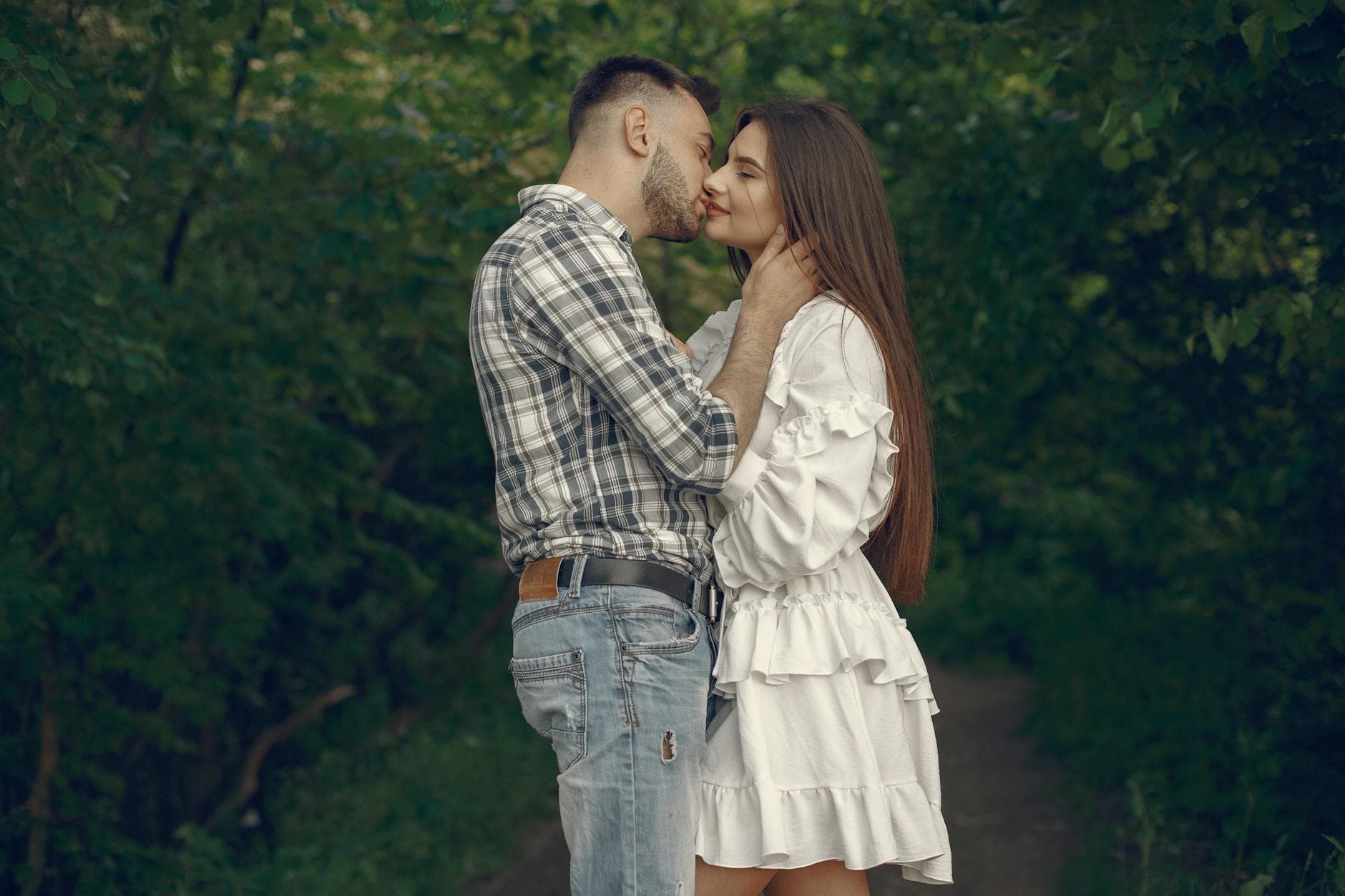 A couple shares a tender moment in a vibrant outdoor setting, conveying love and intimacy. - winter proximity attachment styles