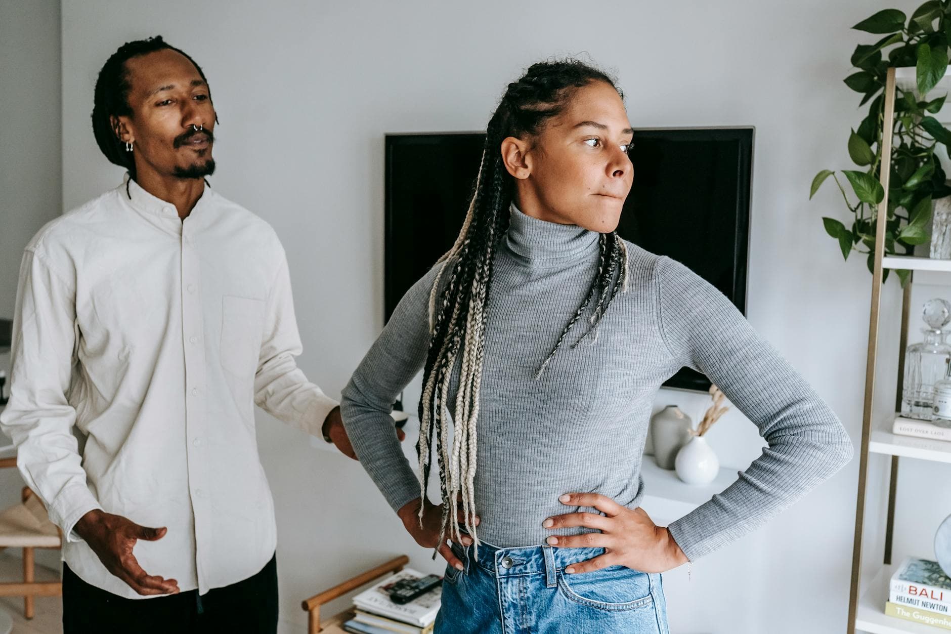 Unhappy African American couple quarreling while spending time together in light modern apartment - how to apologize