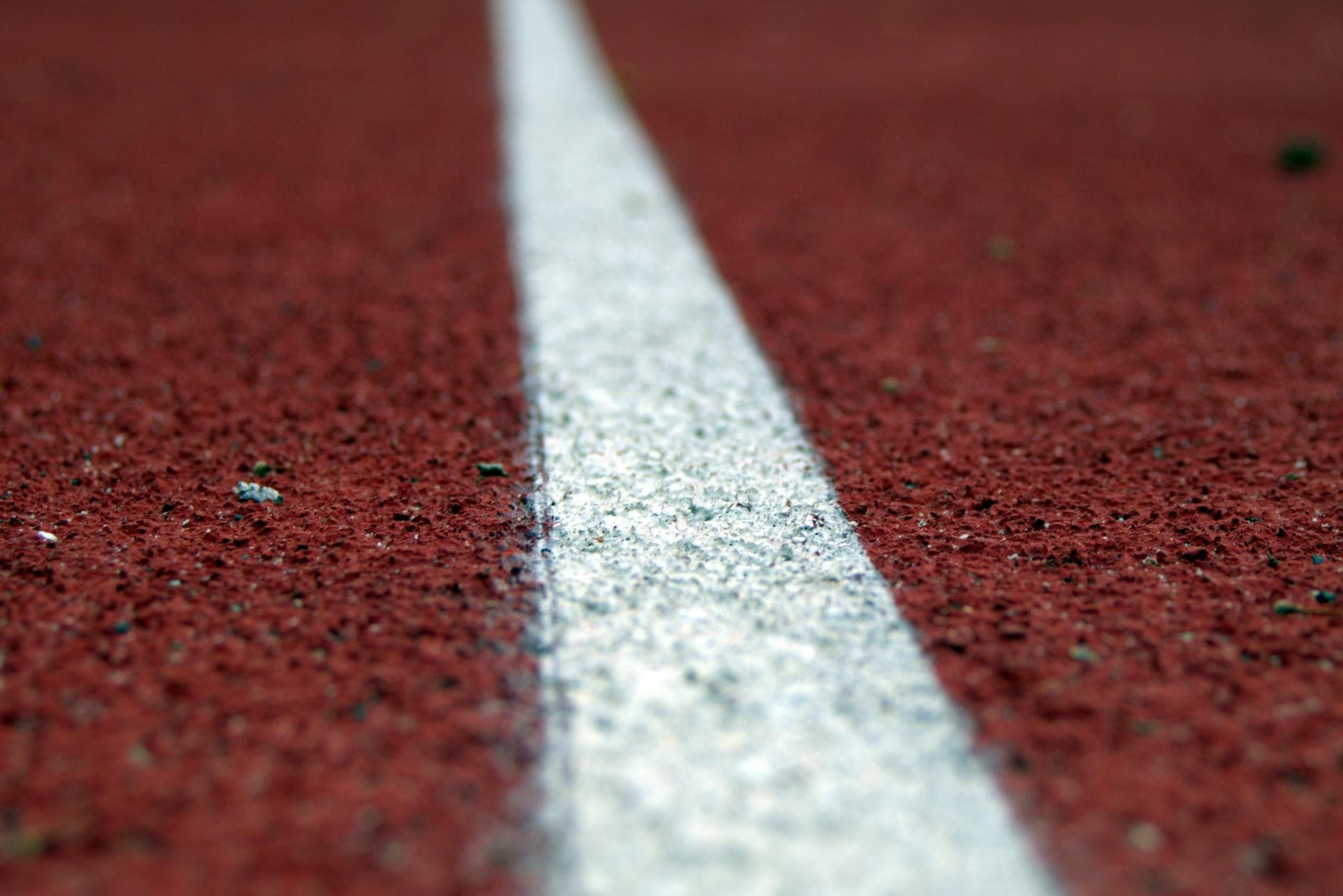 Detailed image of a running track line highlighting texture and pattern. - couple energy boundaries