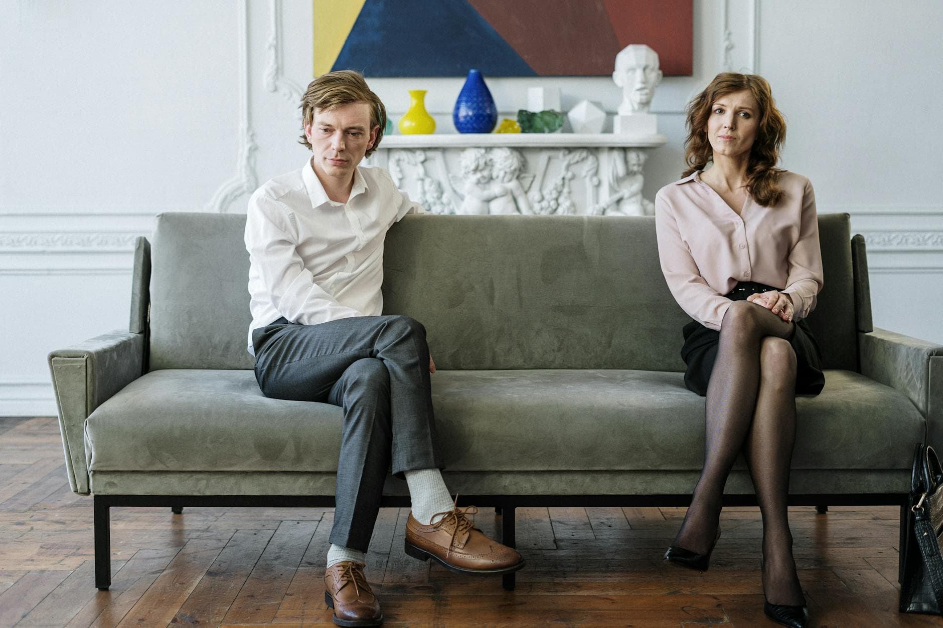 A couple sitting apart during a counseling session, reflecting tension. - couples counseling communication