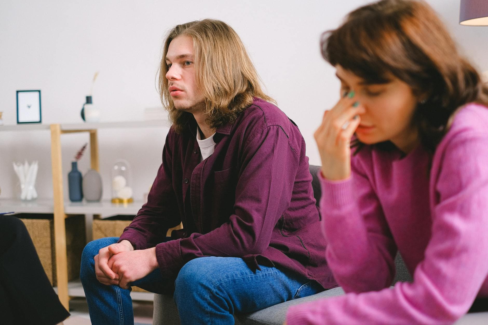 A worried couple sitting during a therapy session, expressing concern. - couples therapy new beginnings