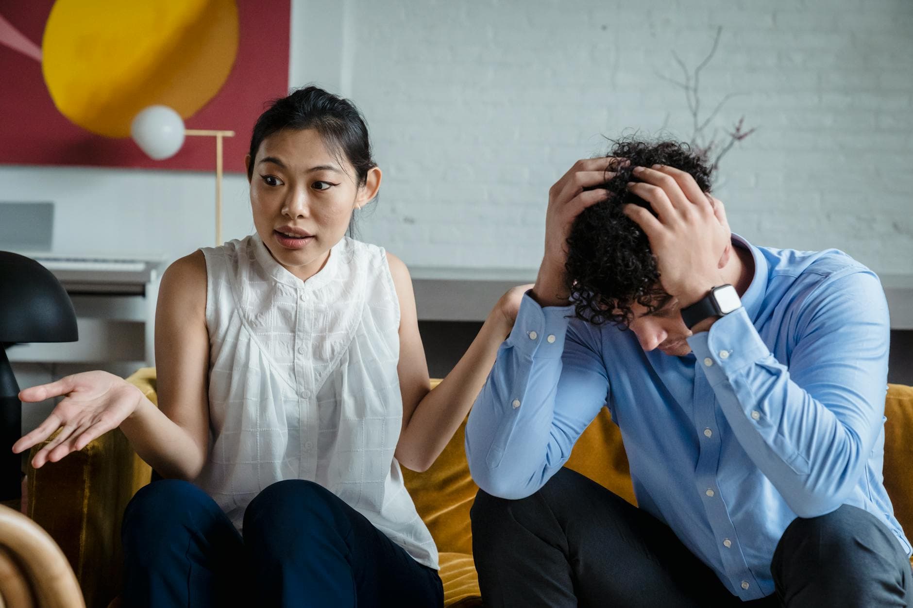A couple having a serious conversation indoors, expressing emotions and misunderstanding. - couples therapy signs