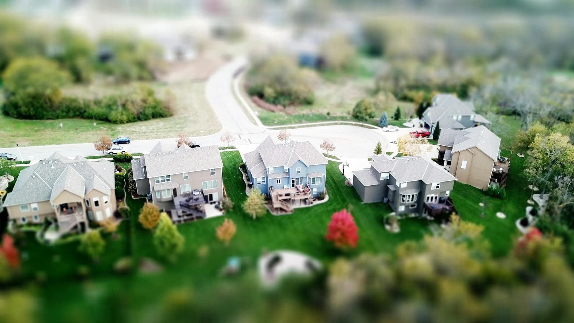 Aerial photo showcasing residential houses in a suburban neighborhood with lush greenery and streets. - effective communication spring plans