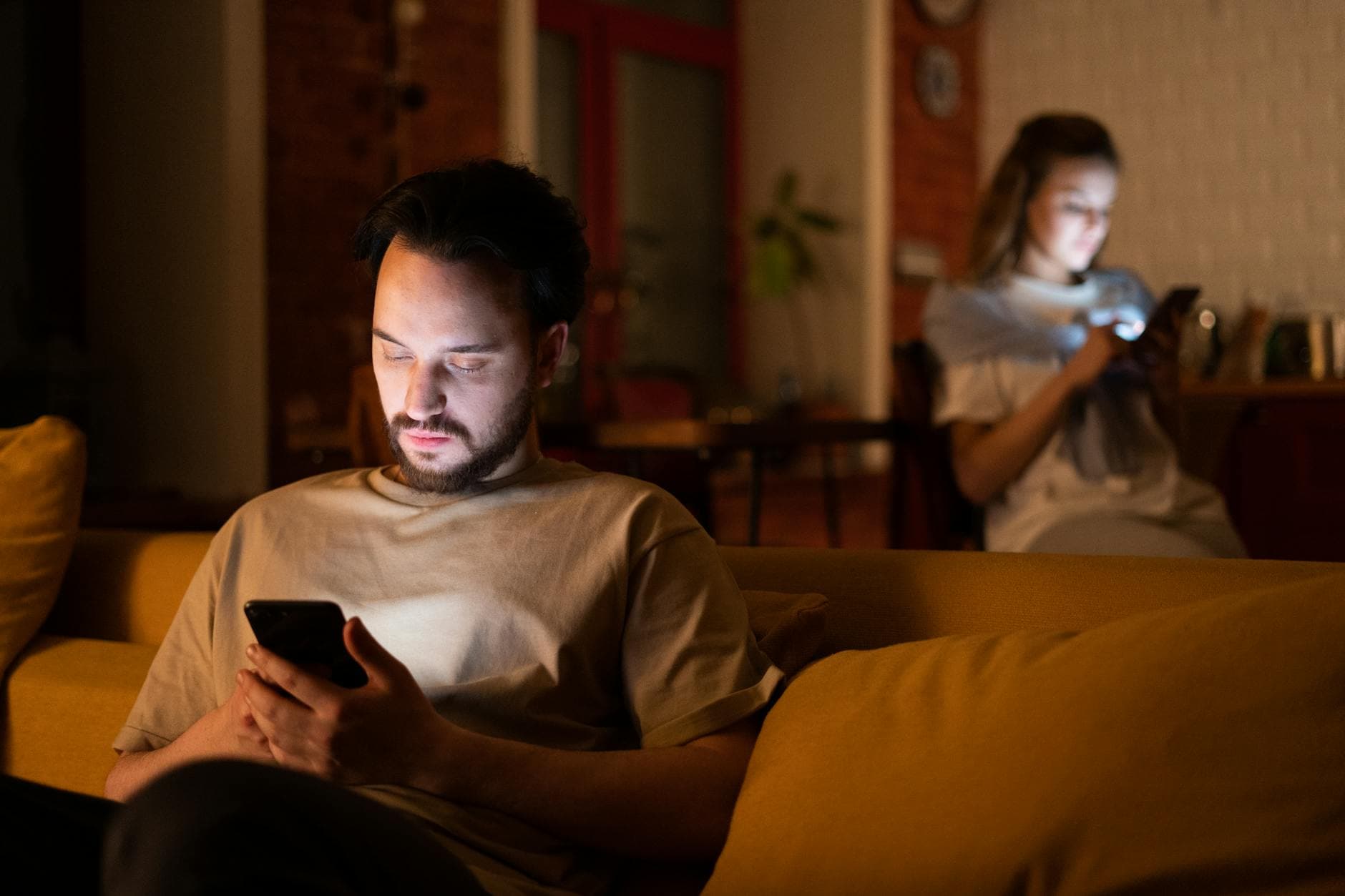 A couple enjoying a cozy evening in a warm home, both using smartphones. - gaslighting examples