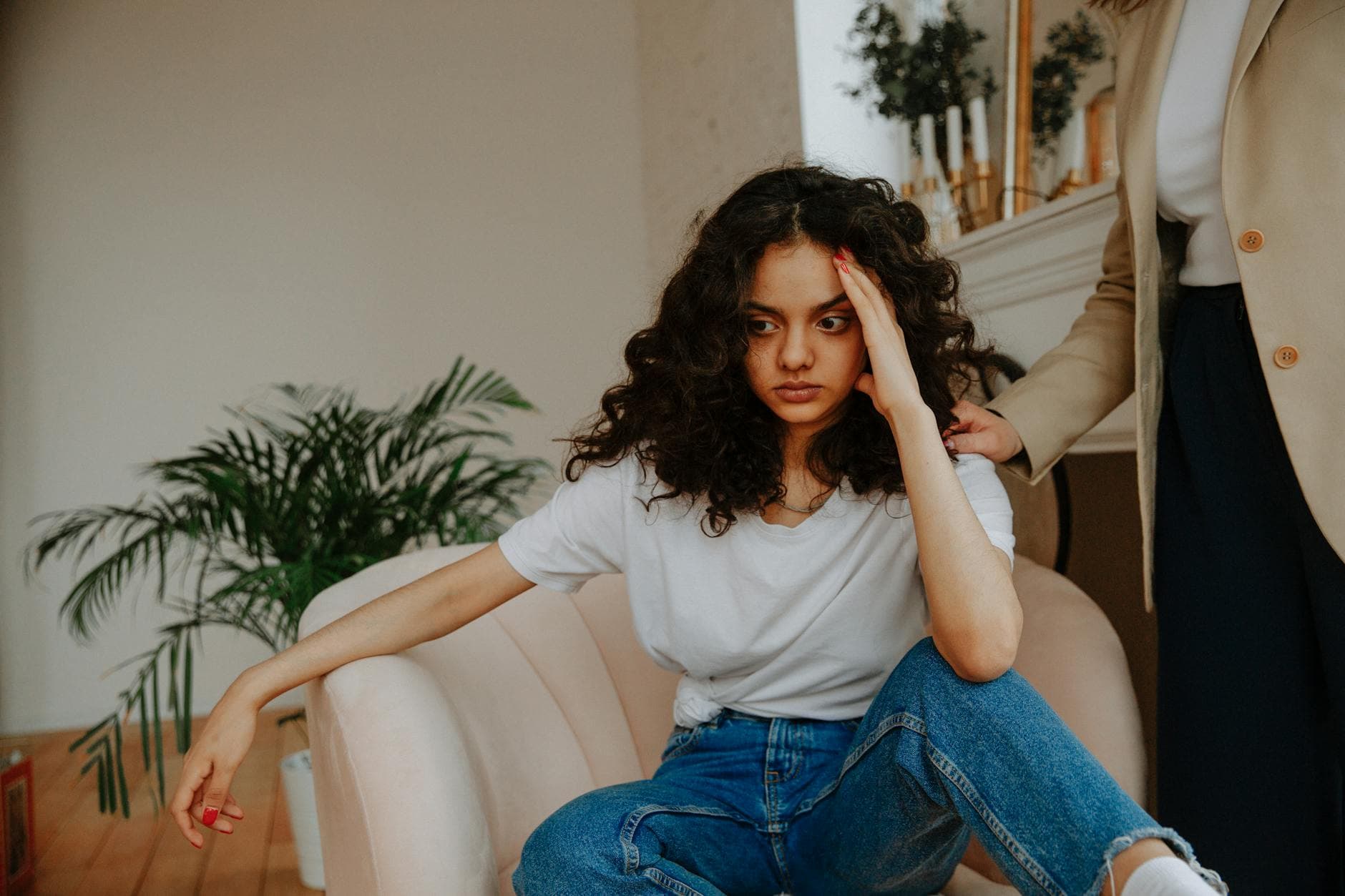 A young woman experiencing a moment of reflection during a therapy session indoors. - what is gaslighting