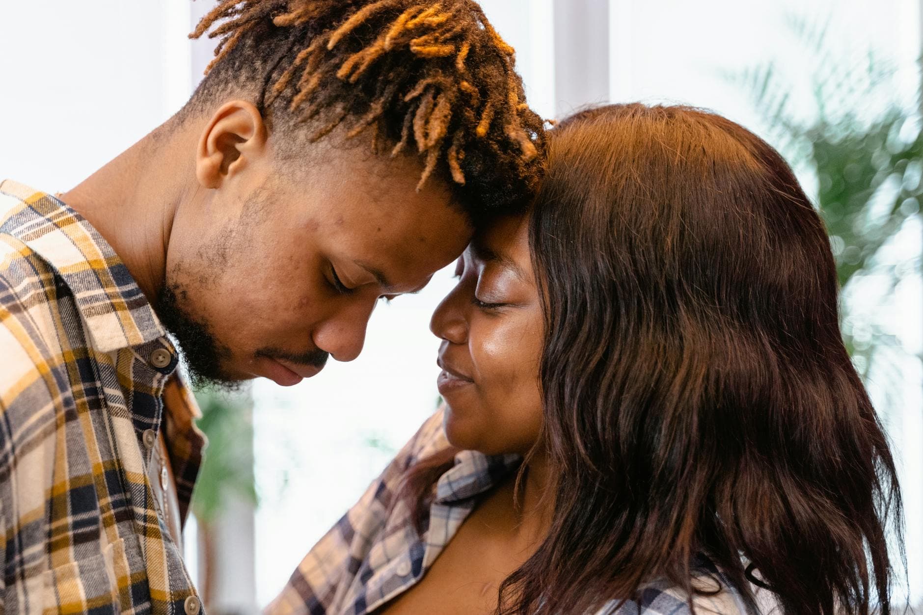 Couple shares a tender moment indoors, symbolizing affection and love. - rebuilding trust couples