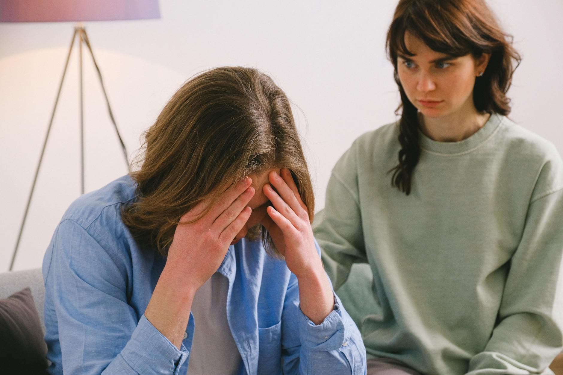 A couple in a tense discussion indoors, depicting stress and mental health focus. - relationship anxiety reddit