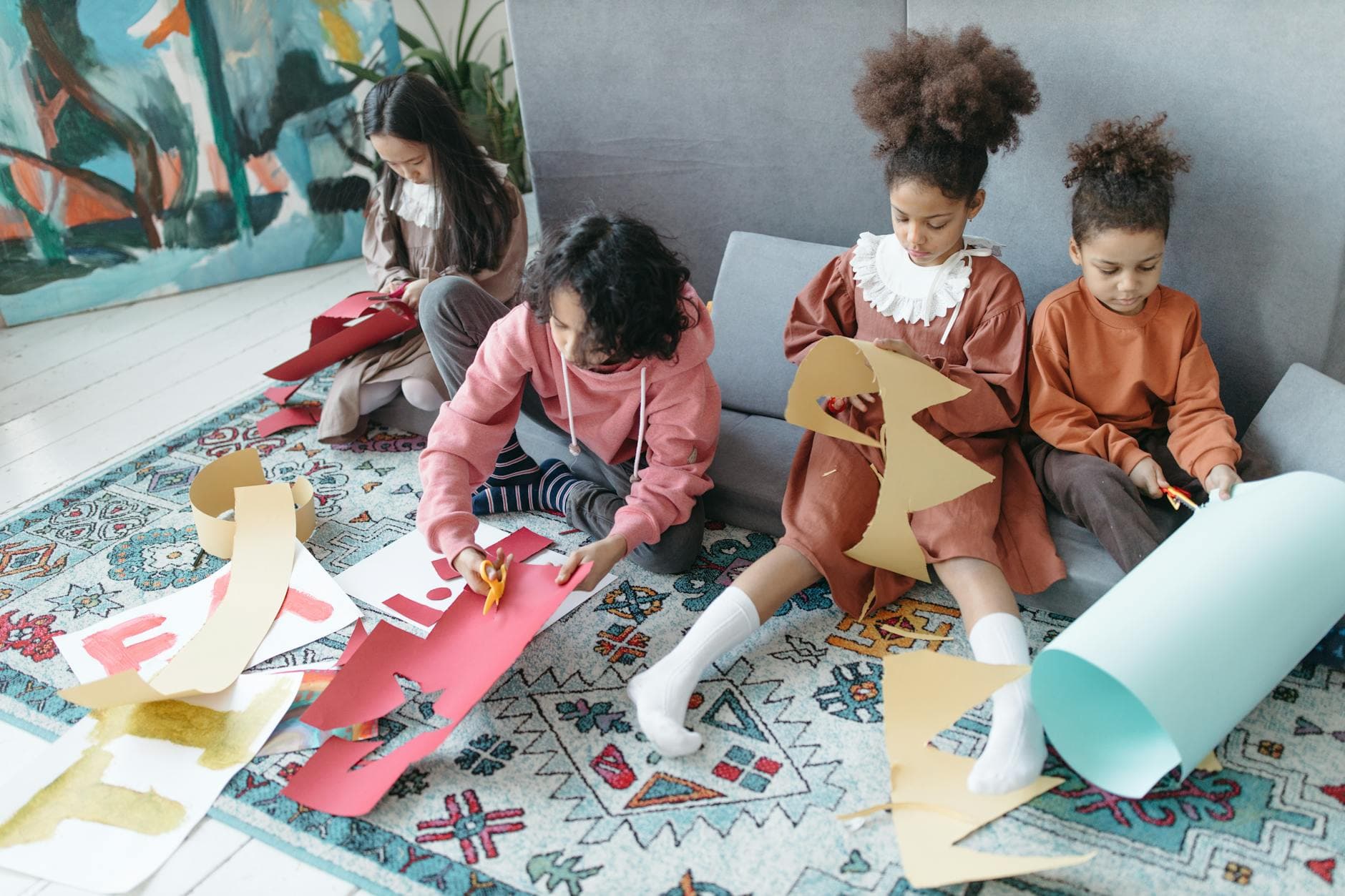 Children cutting colorful papers in a creative arts and crafts workshop, fostering learning and creativity. - social skills activities