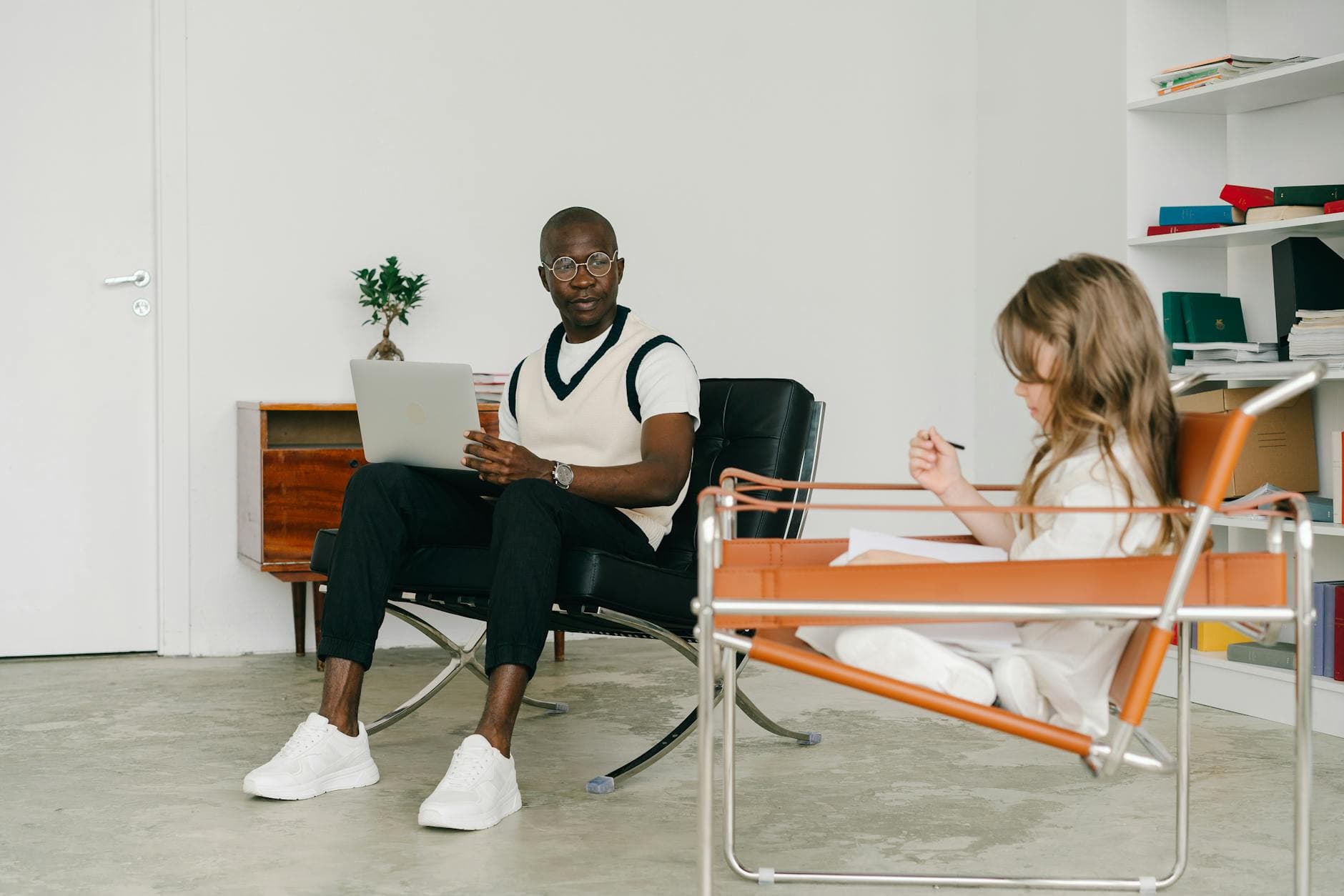 Psychologist and young girl in a therapy room, engaging in conversation and analysis. - spring blues therapy