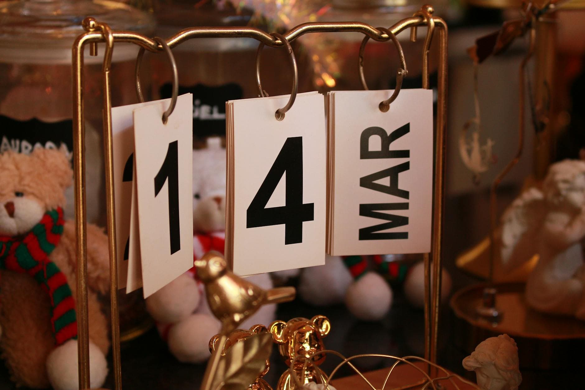 Close-up of a stylish desk calendar showing March 14, surrounded by decorative items. - spring dating tips