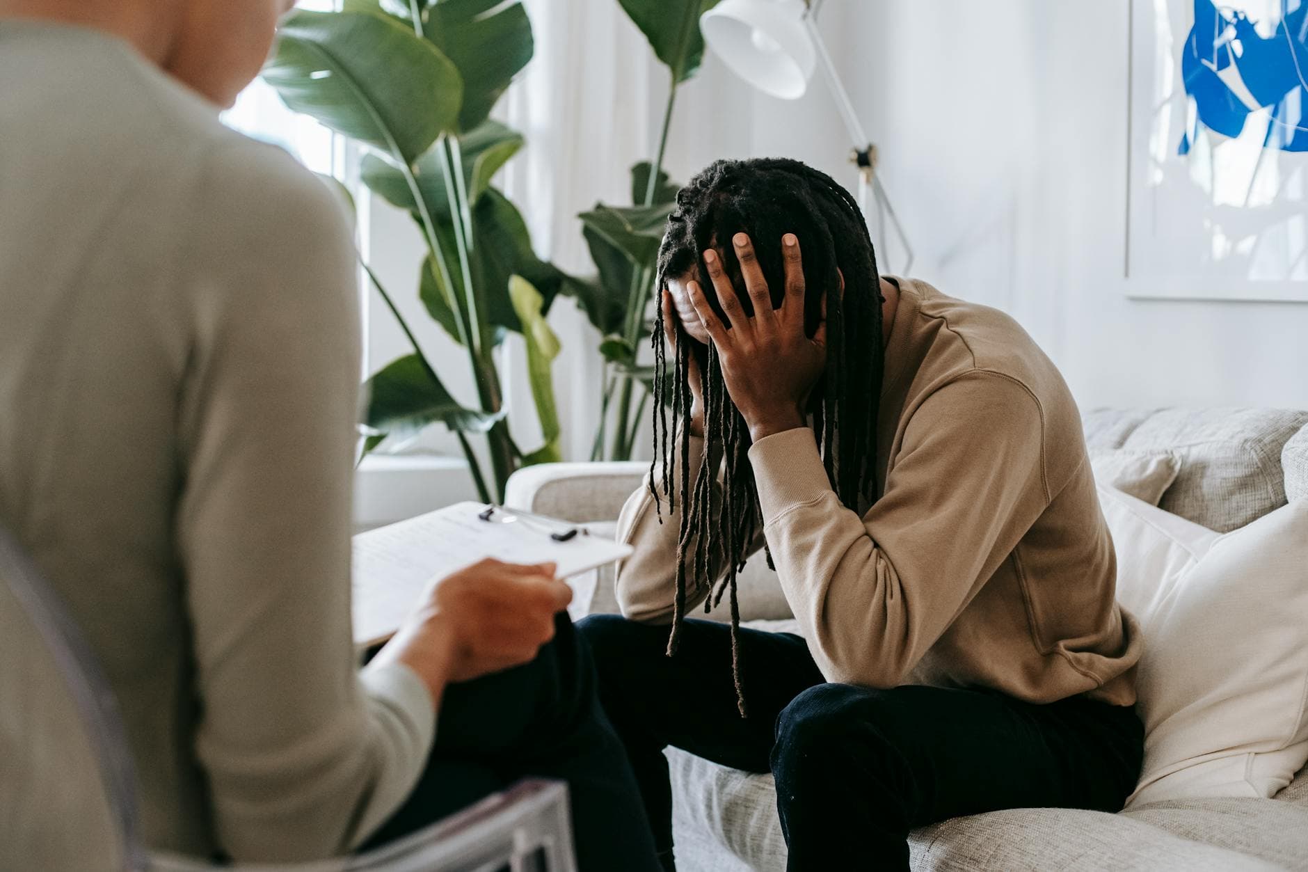 A concerned client in therapy, seeking professional support and guidance indoors. - therapist for seasonal anxiety