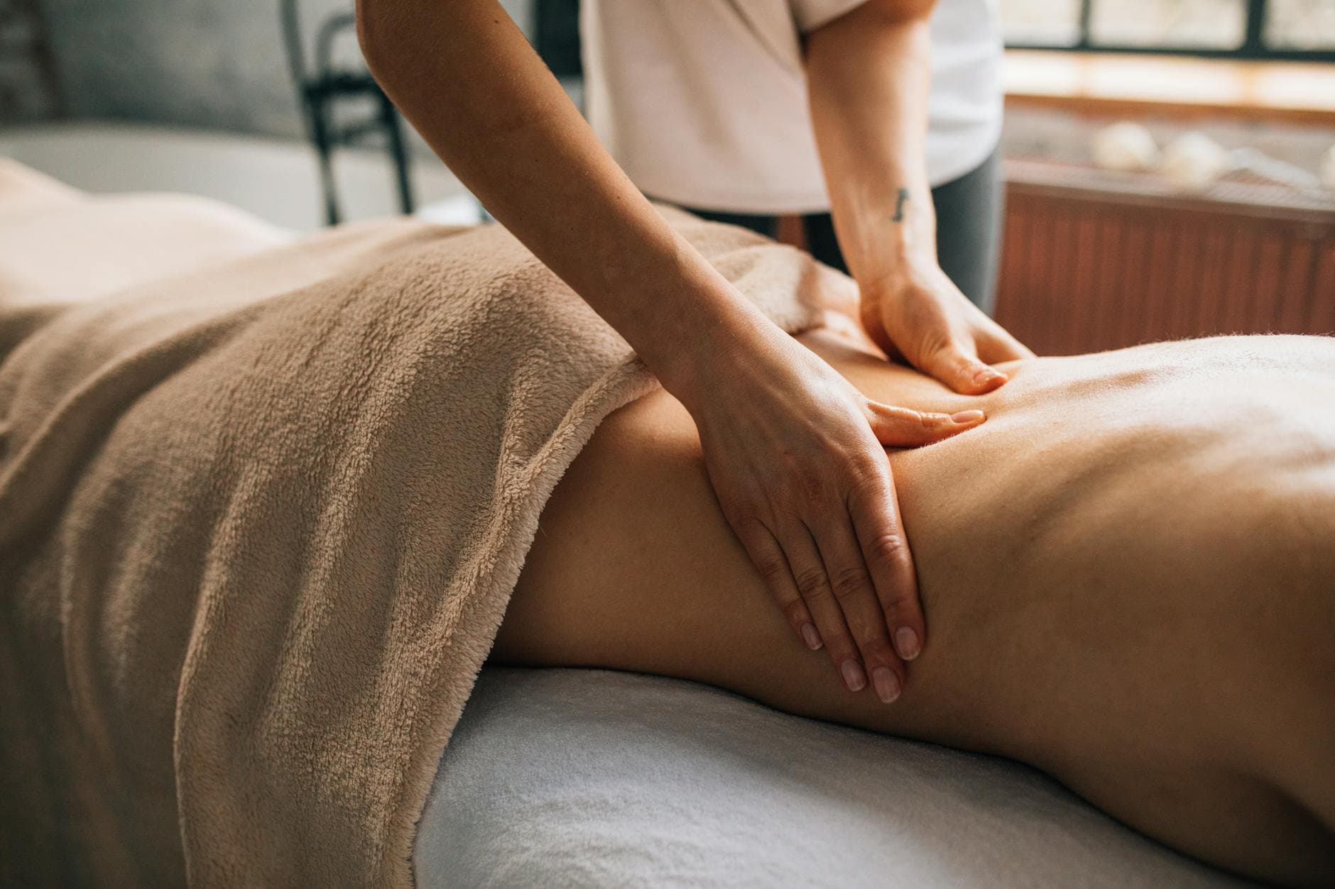 A serene massage session indoors highlighting hands-on body care and relaxation. - allergy stress relief