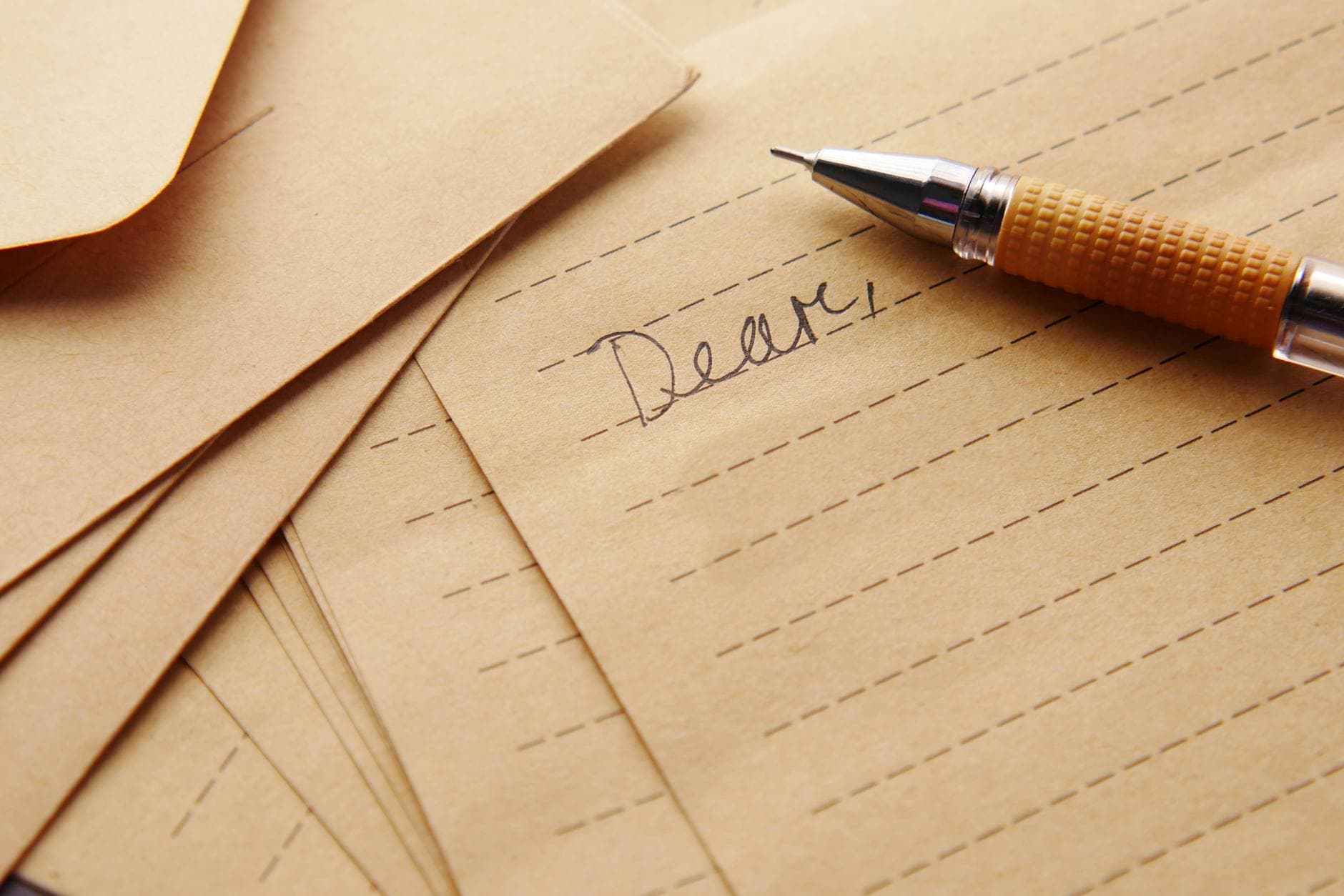 Close-up of vintage lined paper and pen, perfect for letter writing and calligraphy enthusiasts. - bad apology examples