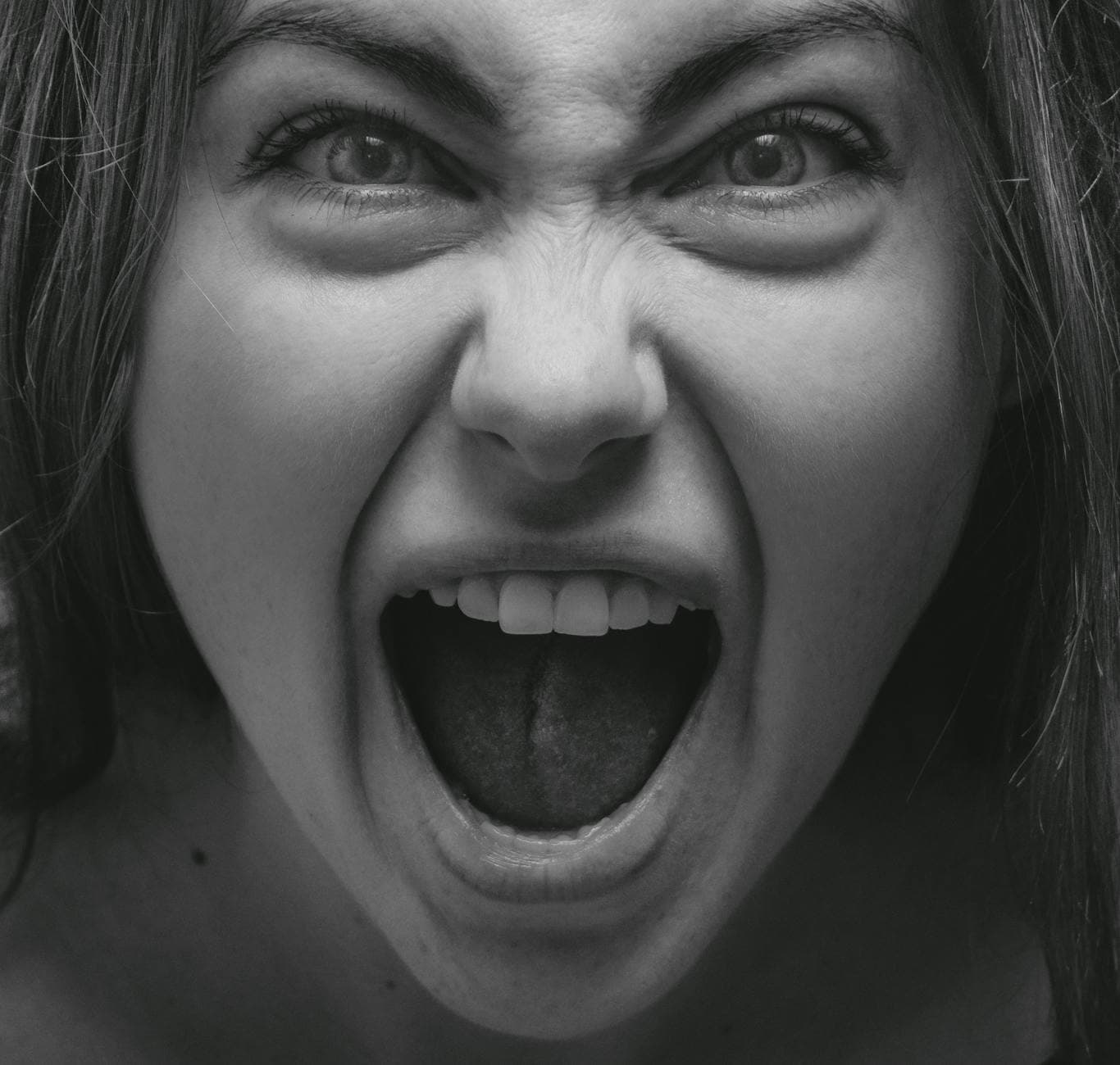 Dramatic grayscale portrait capturing a woman's intense facial expression in Kyiv. - express complex emotions