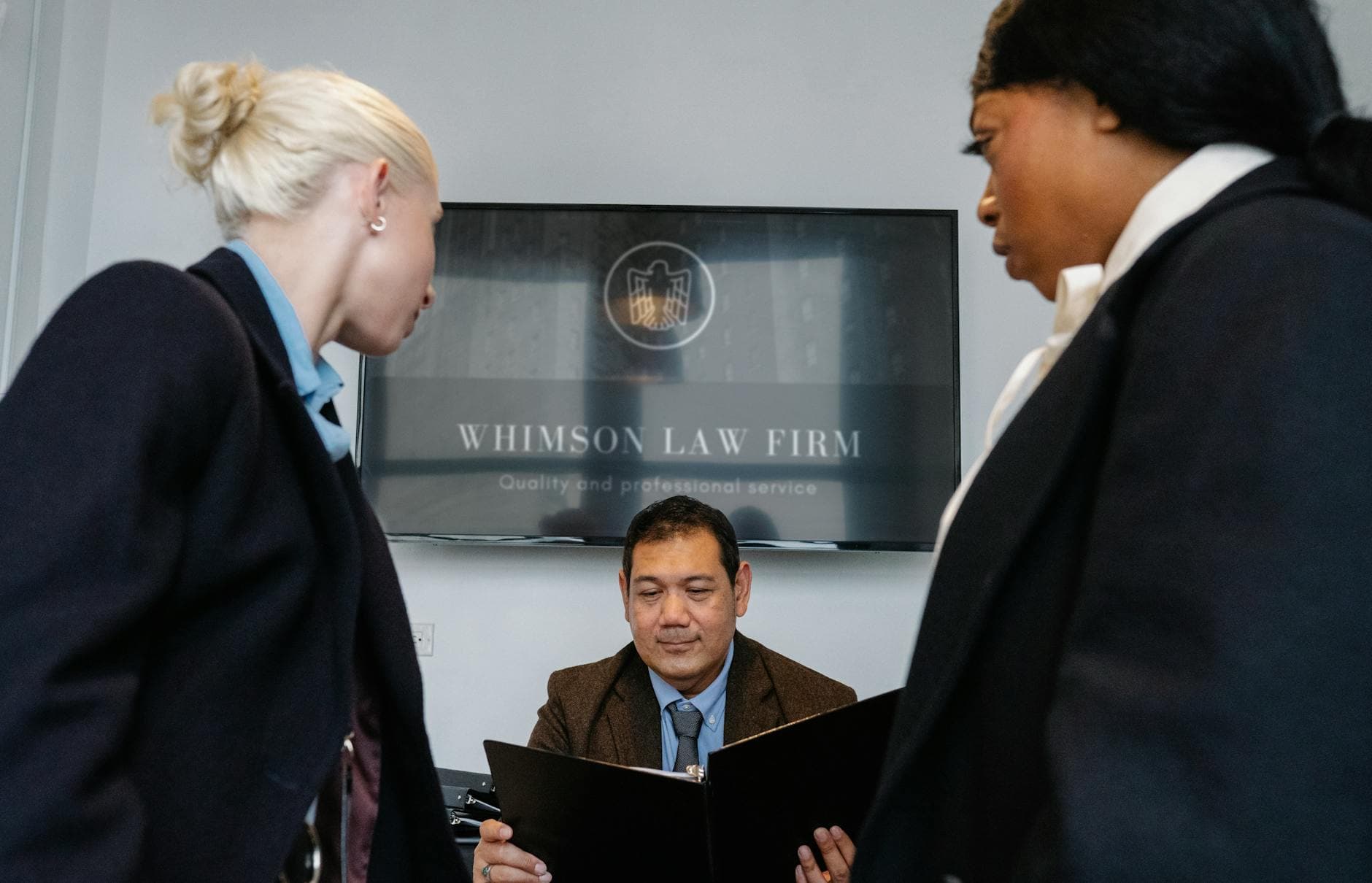 Diverse colleagues gathering in conference hall of law firm and discussing details of contract while working together - what is a resolution
