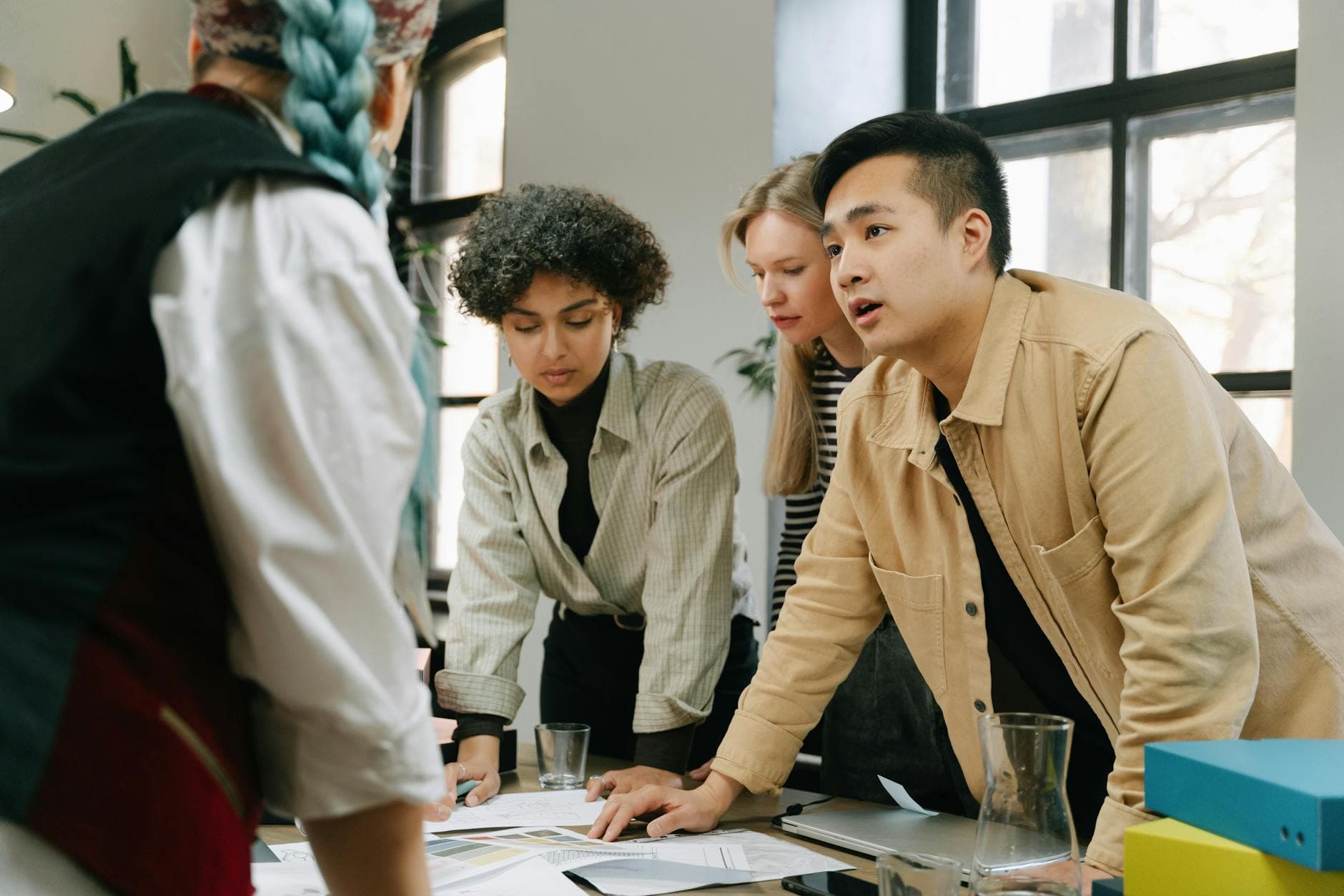 A diverse group of coworkers engaged in a collaborative meeting in a modern office setting. - coparenting communication strategies
