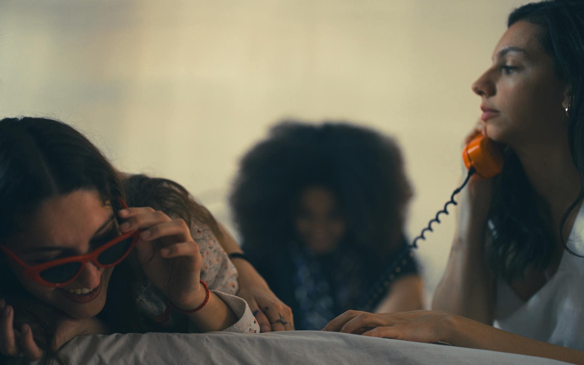 Three women relax indoors, chatting and smiling. Cozy and candid moment. - friends to lovers
