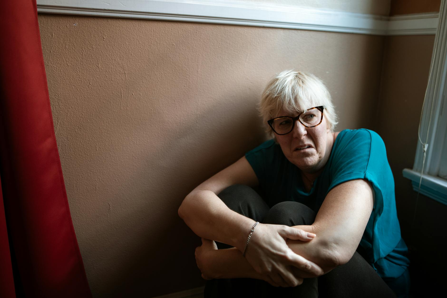 Portrait of an adult woman in thought, representing survival and strength indoors. - charlie sheen mental health struggles