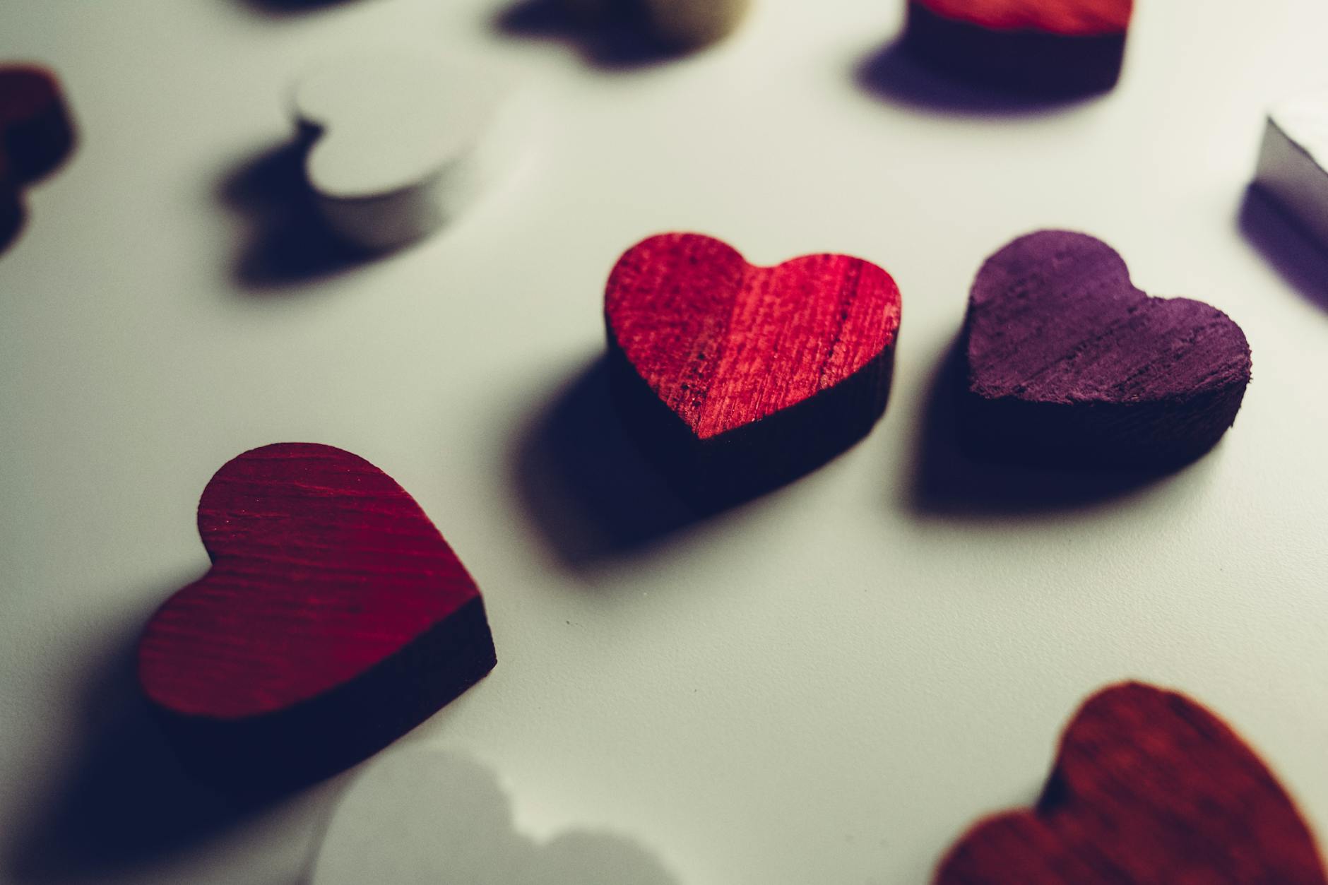 Vibrant wooden heart shapes in red and purple, perfect for Valentine's Day decor. - creative valentine's day ideas