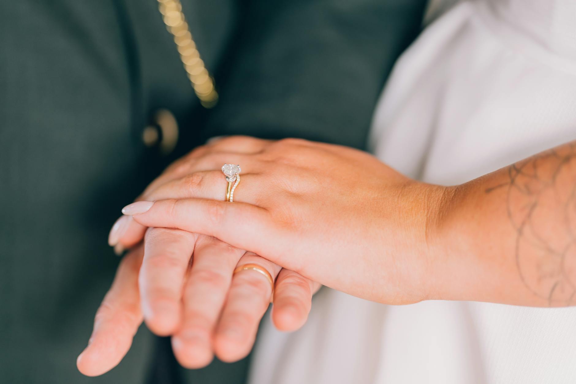 Intimate close-up of couple holding hands, showcasing diamond wedding ring. - fear of commitment new relationship