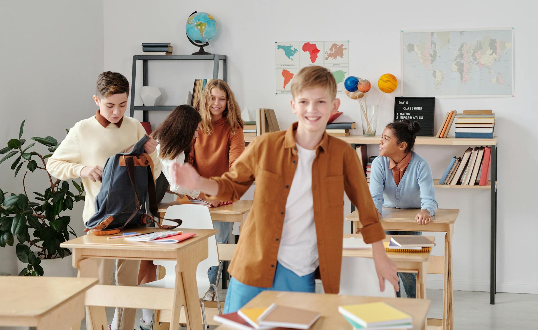 Cheerful students enjoying a break in a lively, diverse classroom setting. - february school break parenting