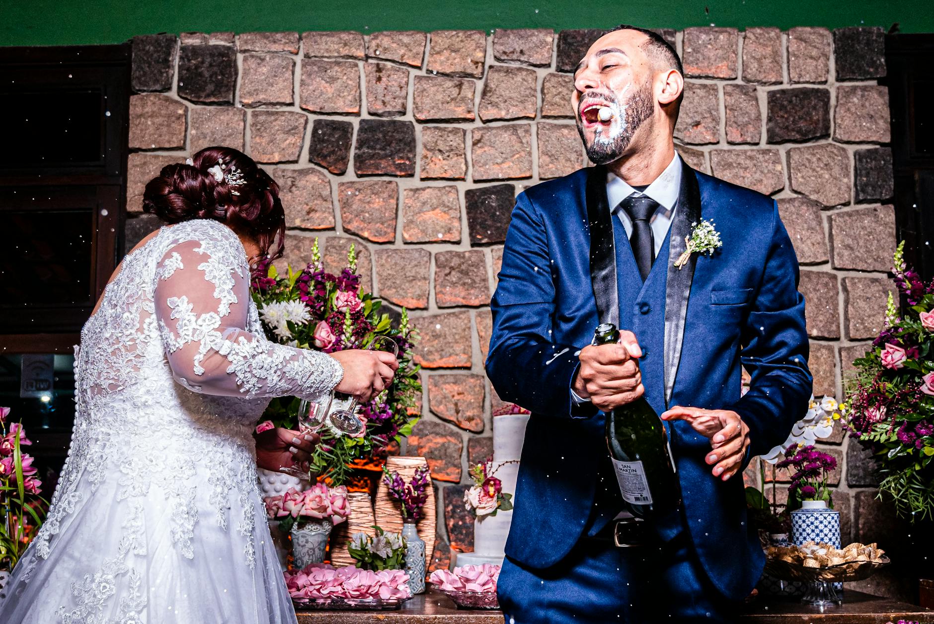 Bride and groom joyfully popping champagne at their wedding, full of laughter and celebration. - funny advice for newlyweds