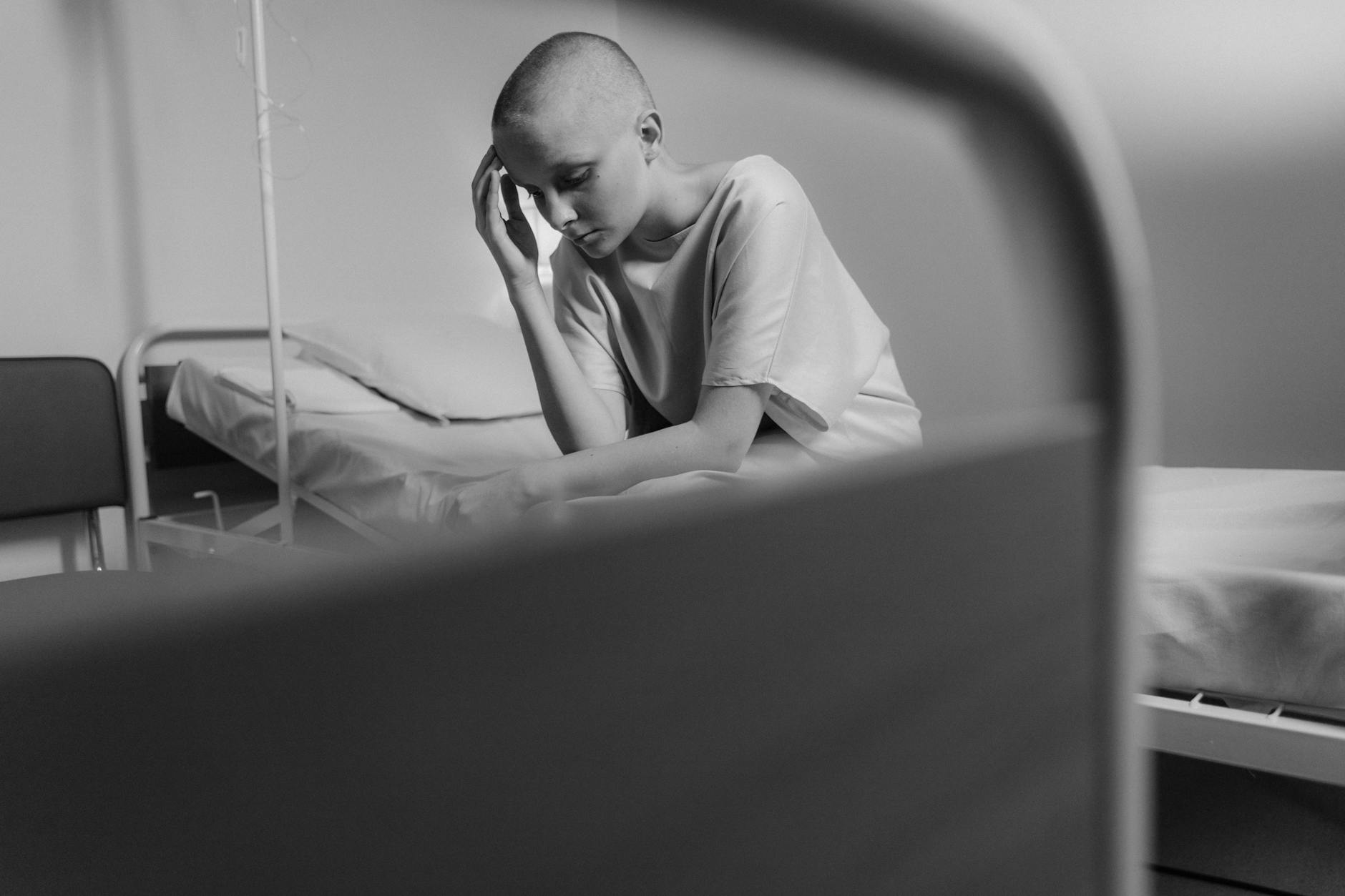 Emotional black and white photo of a woman in a hospital setting, representing vulnerability and courage. - latest postpartum depression treatments