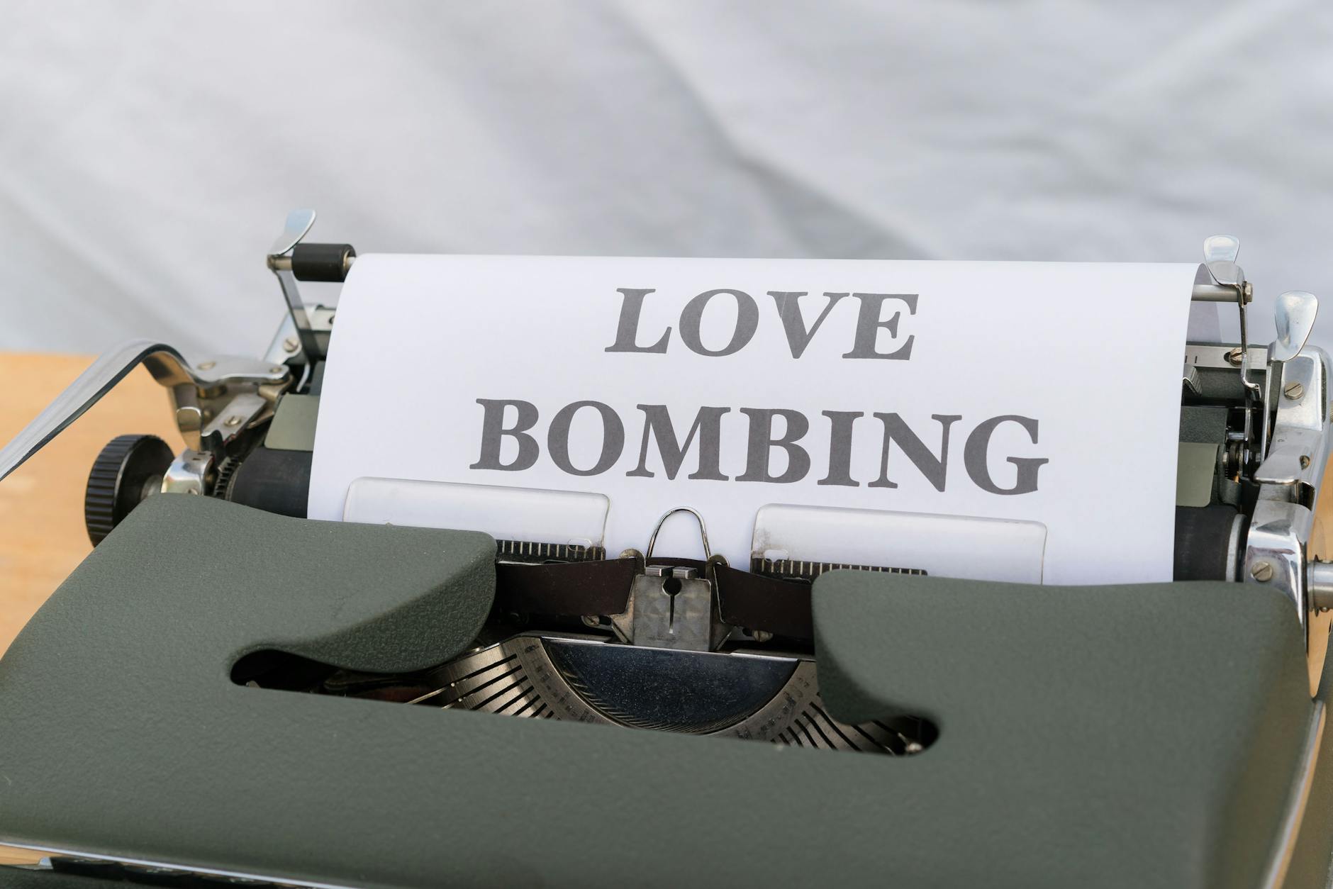 Close-up of a typewriter displaying the phrase 'Love Bombing' on paper. - narcissistic abuse recovery