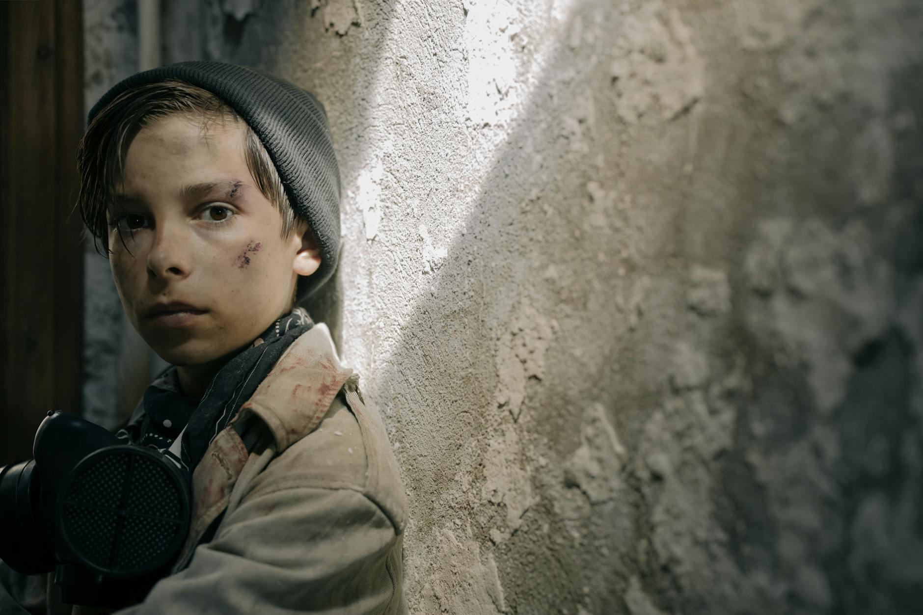A young boy in a post-apocalyptic setting looking determined, wearing survival gear. - post-holiday relationship struggles