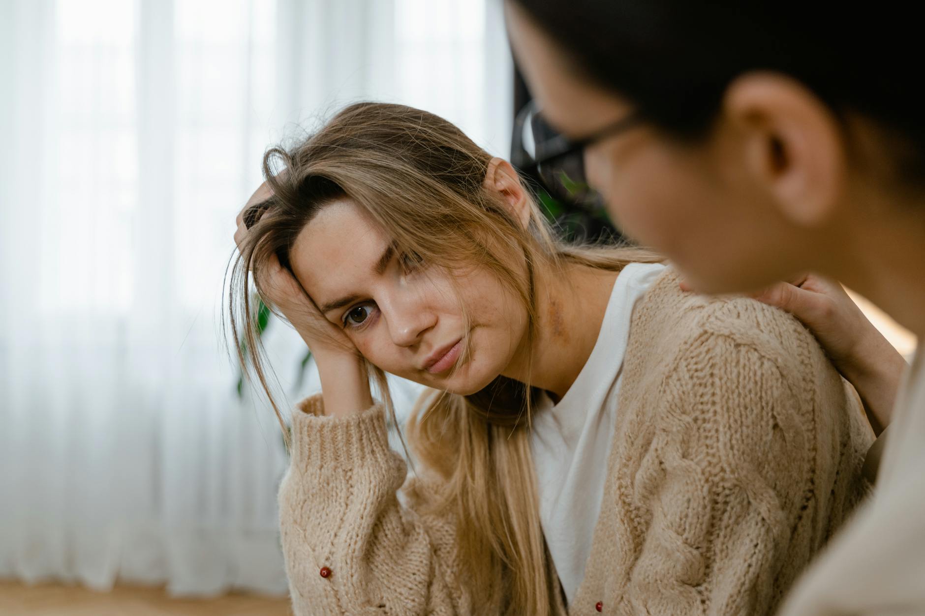 Woman receiving comforting support, showing empathy and understanding in a thoughtful indoors setting. - rebuild intimacy after stress