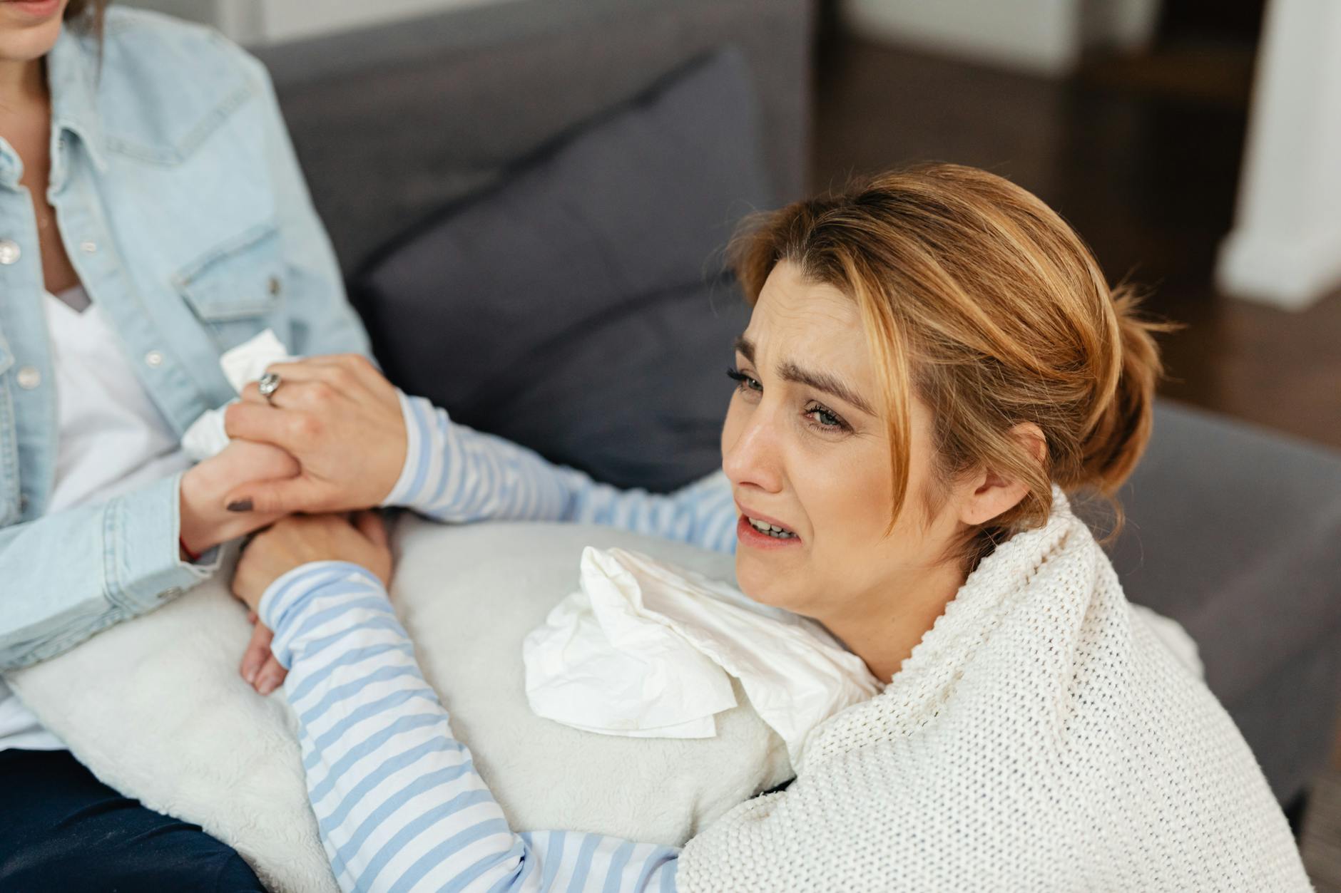 A crying woman is comforted by a friend, showcasing emotional support and empathy. - rebuild intimacy after stress