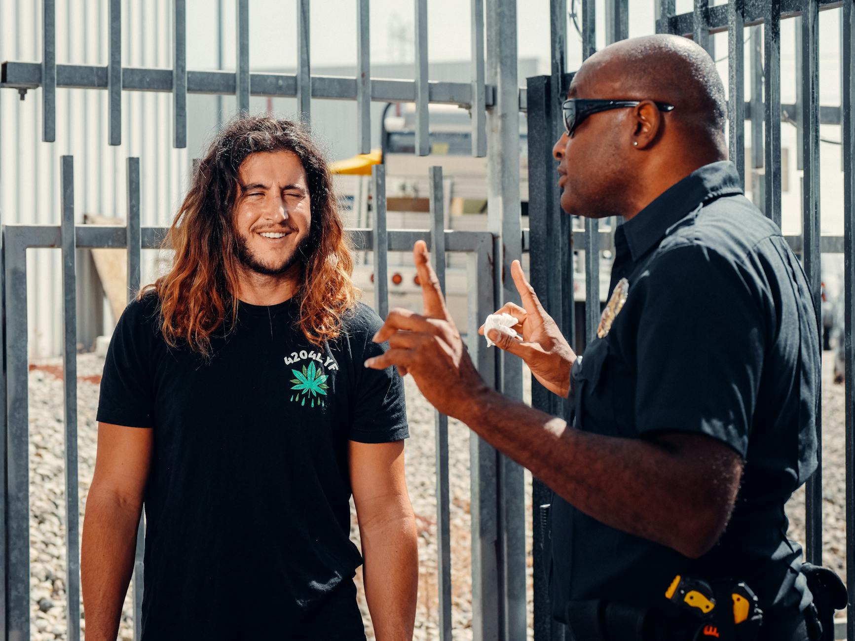 A police officer engages in conversation with a civilian outside on a sunny day. - rebuilding trust after affair