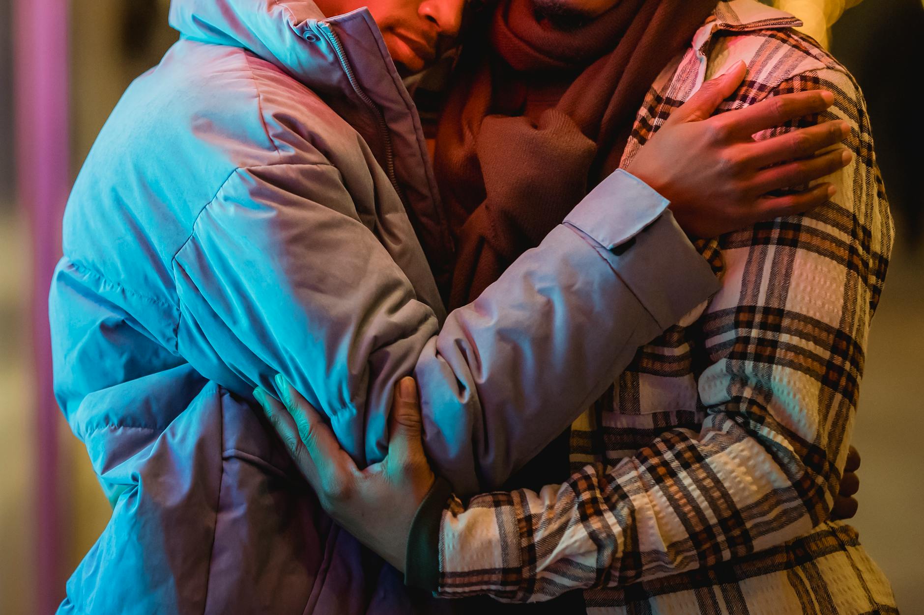 A tender moment shared between a couple warmly dressed in winter layers, highlighting love and unity. - support partner winter blues