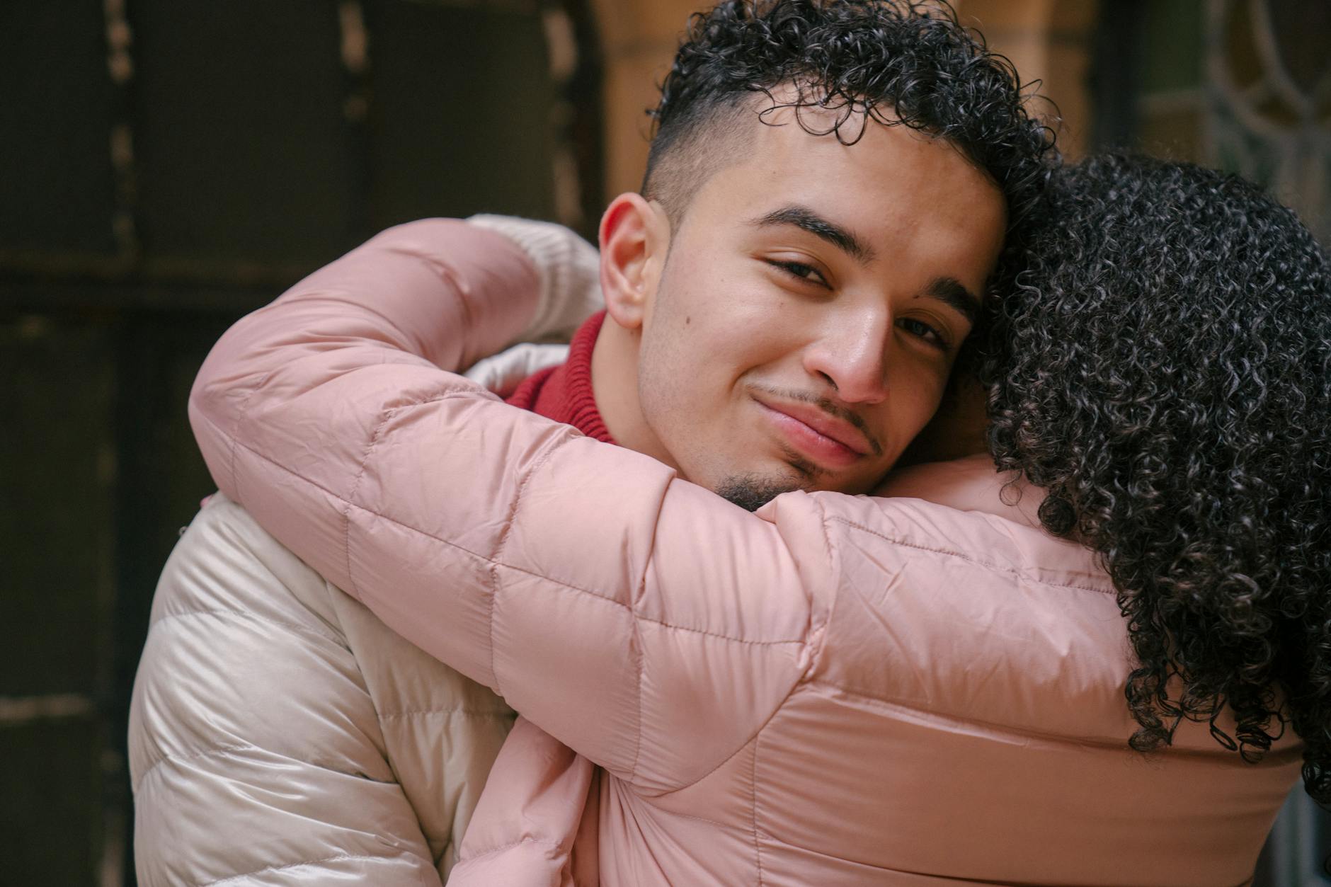 A tender moment as a young couple shares an embrace, showcasing love and affection. - support partner winter blues