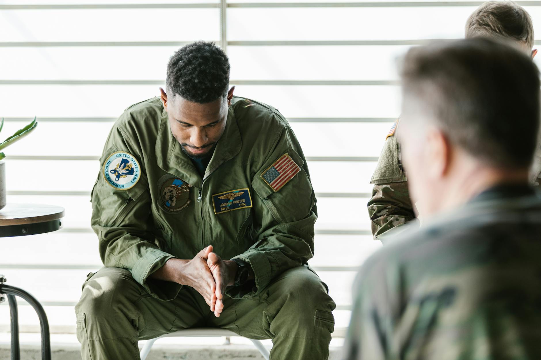 A soldier dressed in uniform sits pensively during a counseling session, embodying themes of mental health and support. - therapy for winter loneliness