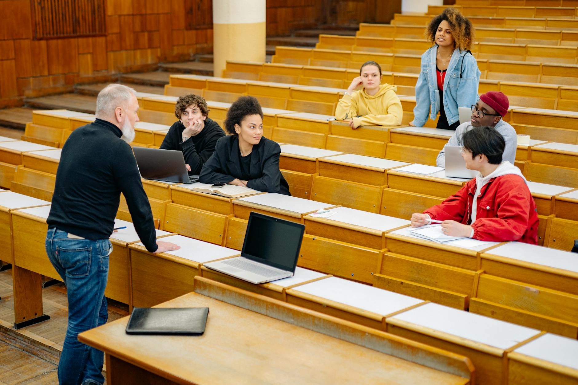 Students actively listening and engaging in a university lecture setting, showcasing diversity. - active listening difficult conversations