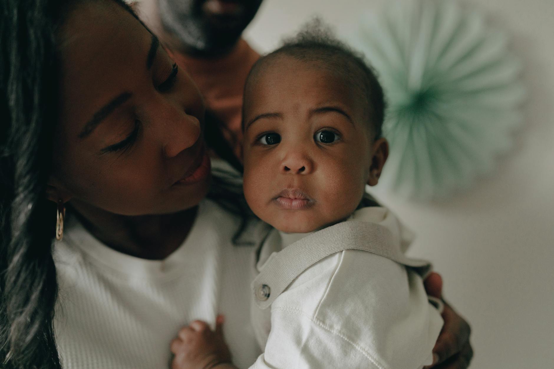 Tender moment between a mother and baby, capturing love and curiosity. - anxious attachment style