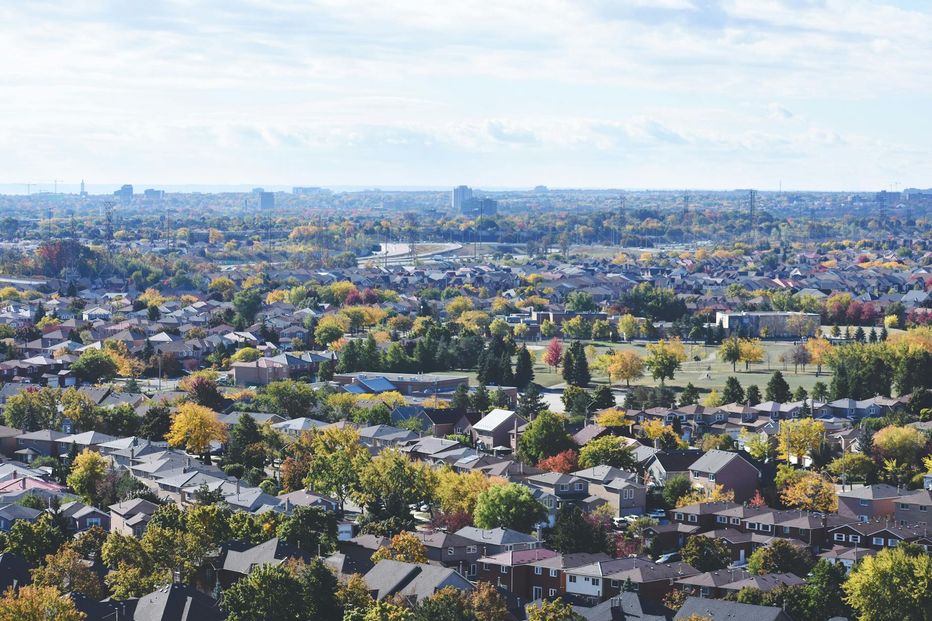 Discover a vibrant aerial view of a suburban neighborhood during autumn, alive with color. - communication habits