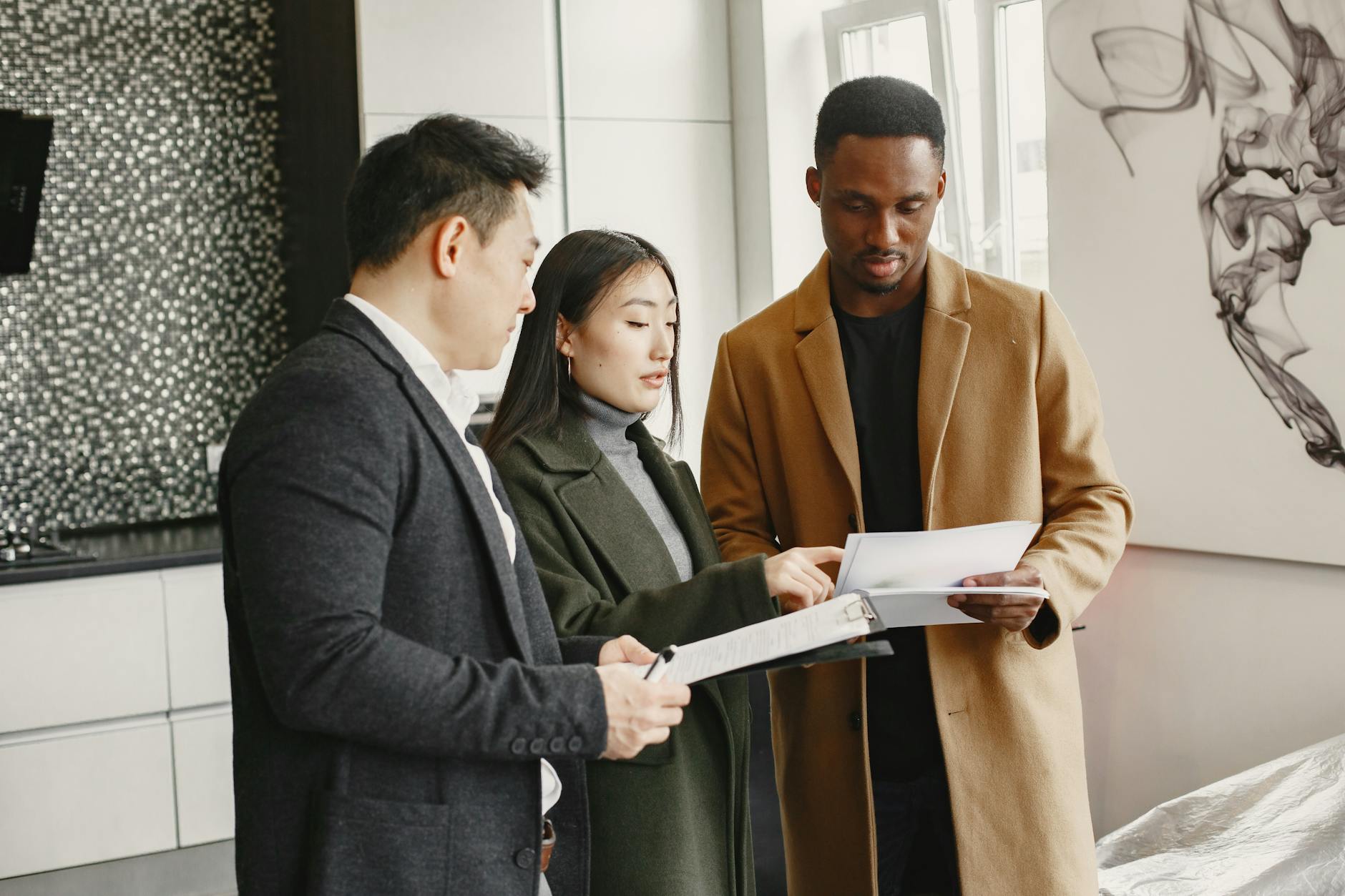 A diverse group of adults collaborates indoors on a project, examining documents and planning. - couple communication skills