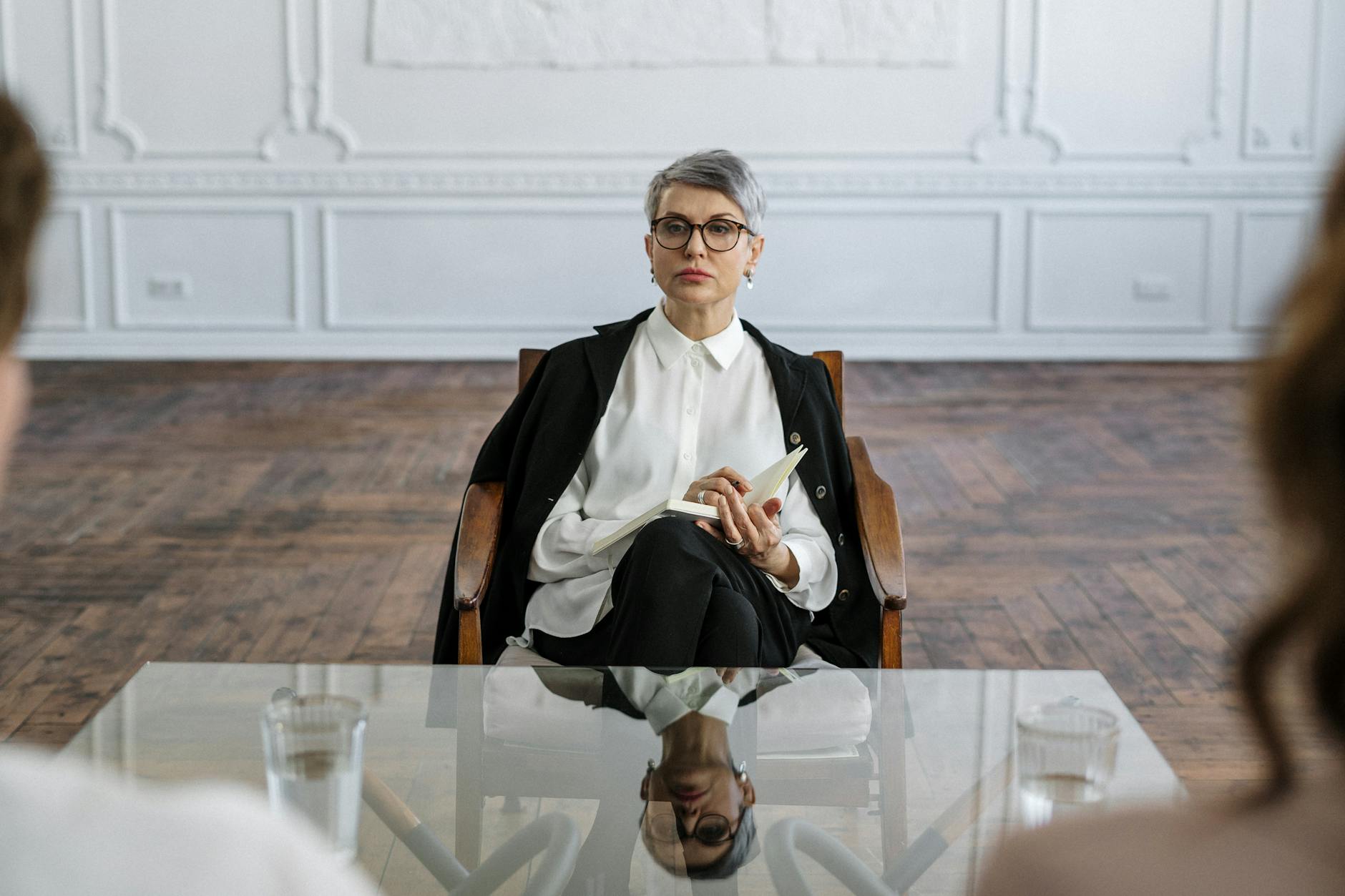A therapist conducts a session in a stylish, minimalistic office, creating a supportive and professional atmosphere. - couples therapy guide