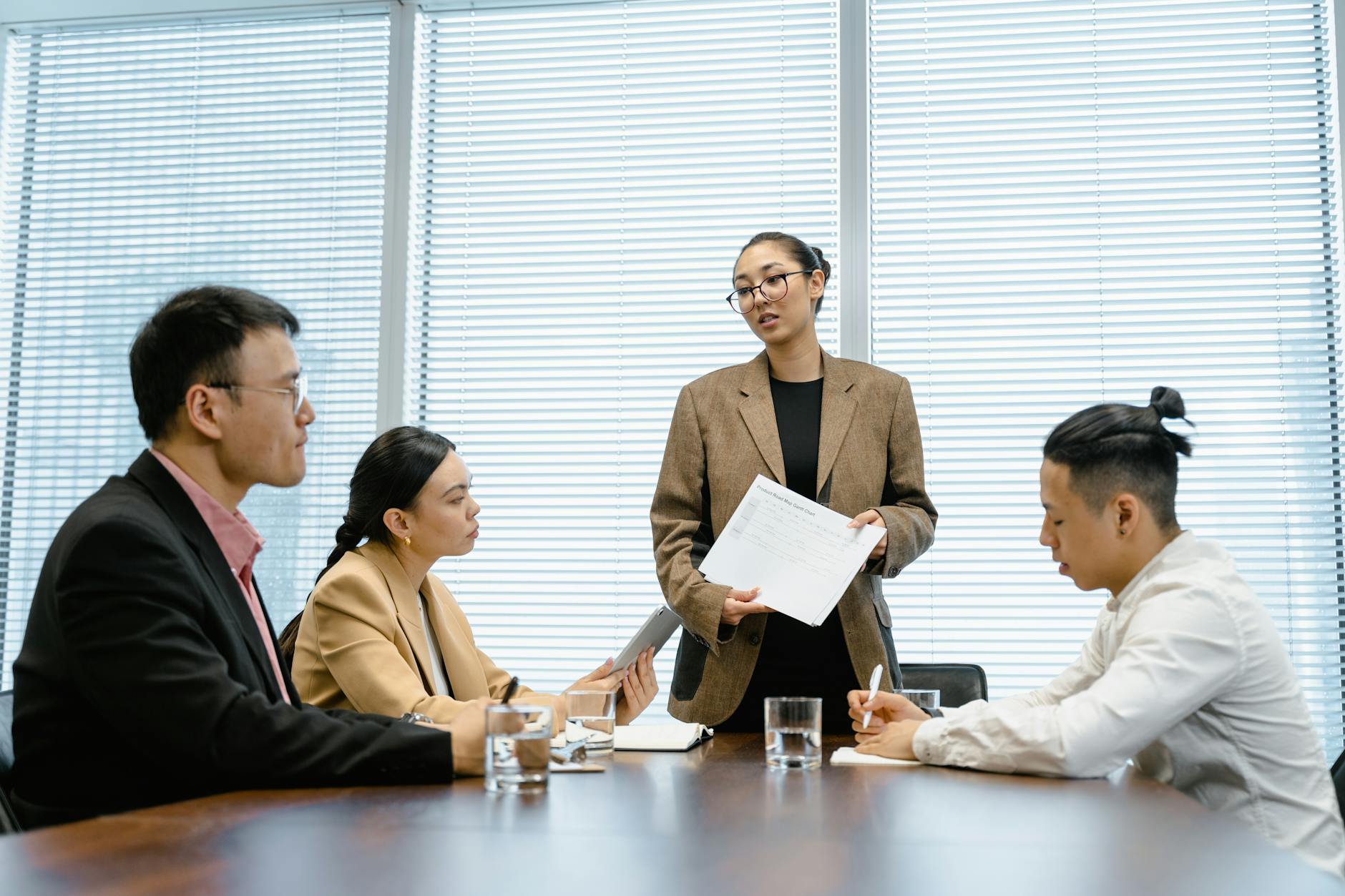 Business professionals in a modern office engaged in a teamwork session. - define assertive communication
