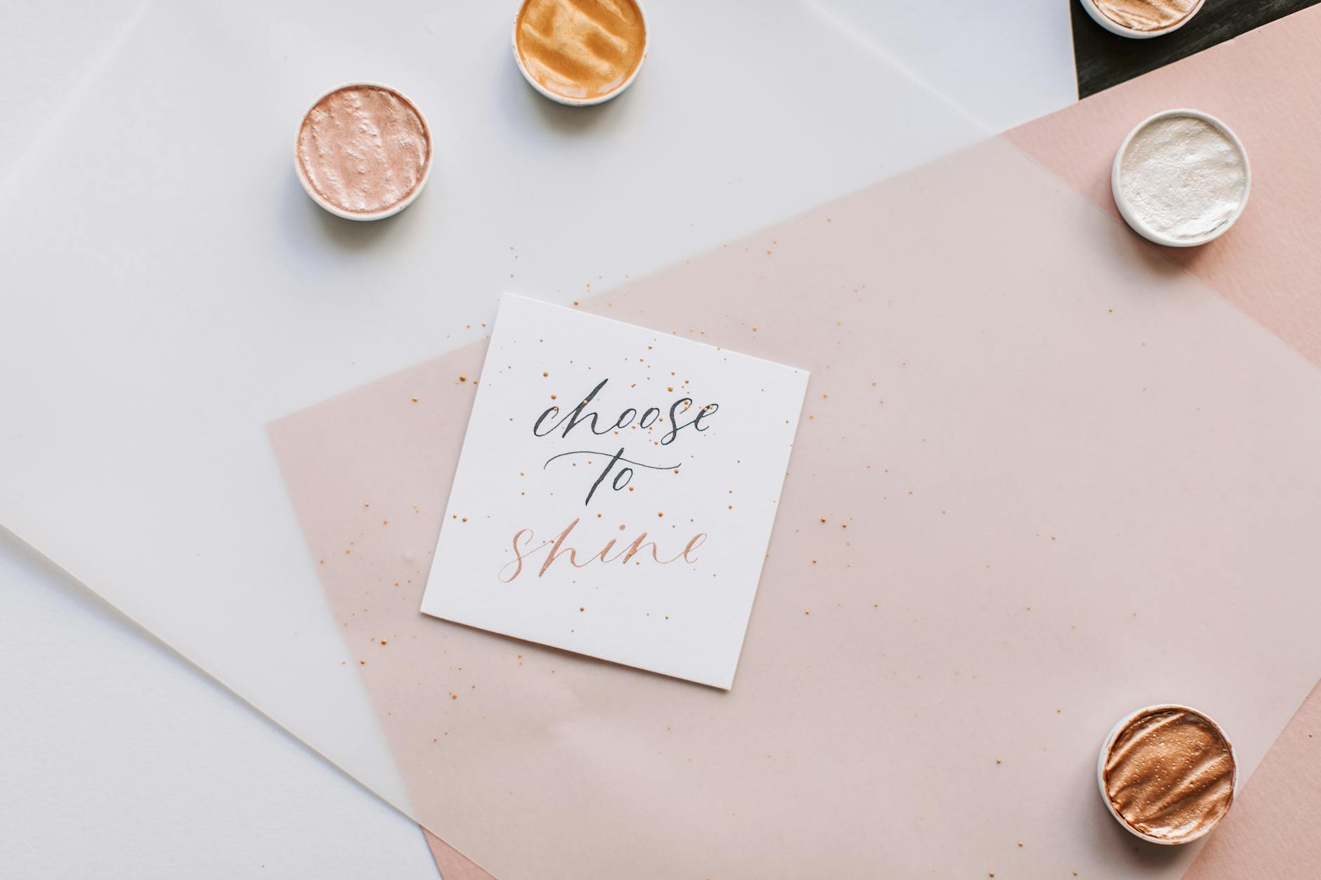 Flat lay of motivational quote 'Choose to Shine' in elegant calligraphy with metallic accents. - empty nest quotes