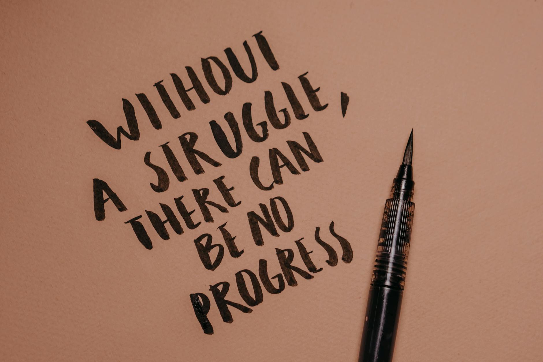 Handwritten motivational quote using a brush pen on a textured background for inspiration. - empty nest quotes