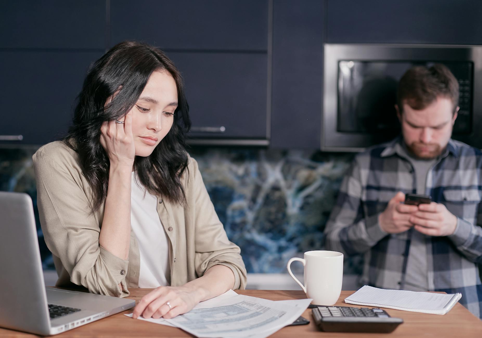 Couple experiencing stress while managing household finances at home. - financial stress couple