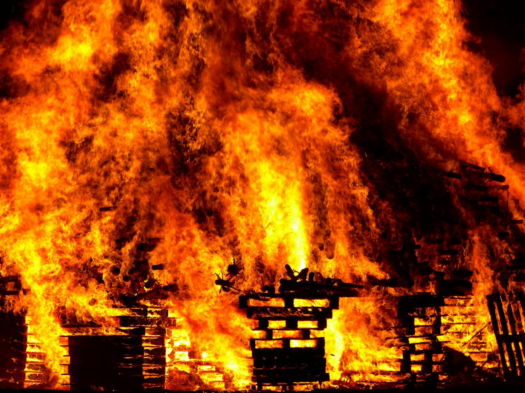 Intense flames engulf wooden pallets in a breathtaking display of fire and heat. - funny marriage tips