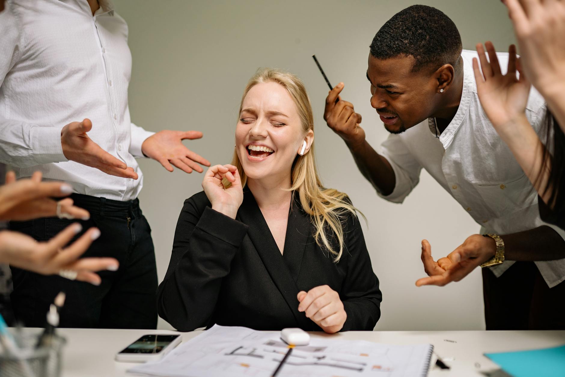 Conceptual image of office conflict with a woman facing workplace pressure surrounded by colleagues. - managing family conflict spring holidays