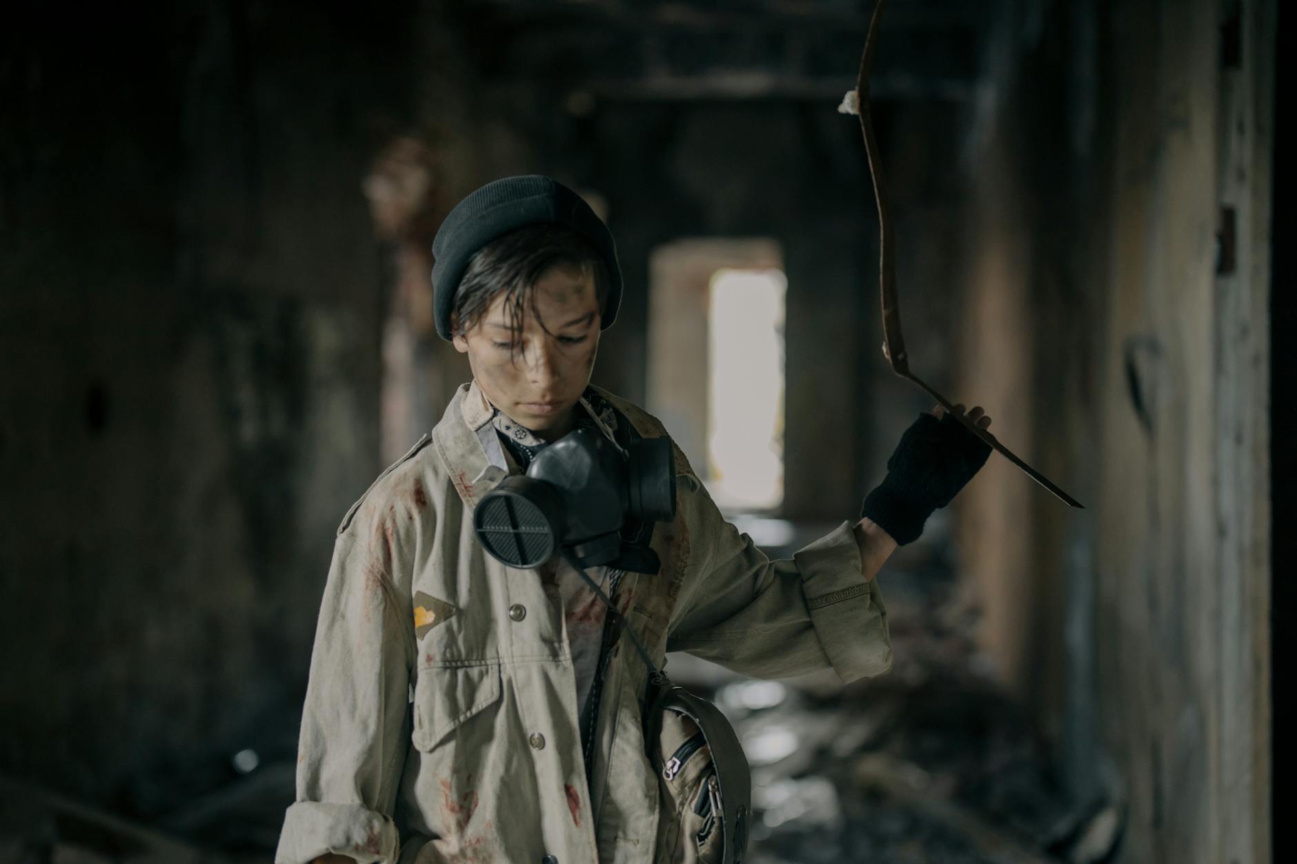 Young survivor with respirator exploring a decaying structure, embodying post-apocalyptic solitude. - post winter loneliness